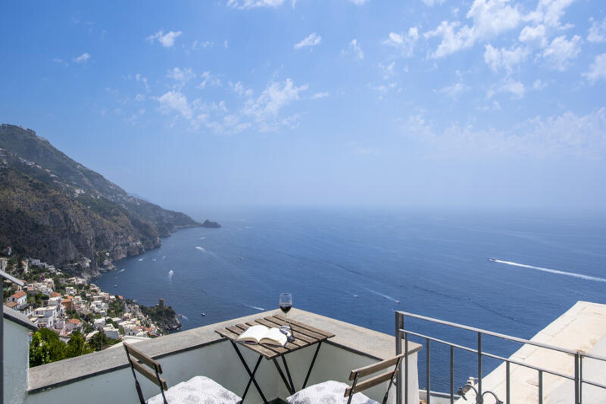 Perched in the serene heights of Praiano, Casa Punta Paradiso is a romantic haven that offers breathtaking views of the Mediterranean Sea and the rugged beauty of Capo di Conca. Just steps from the charming square of the Church of Costantinopoli, this exclusive retreat is perfectly positioned to provide tranquility while remaining close to the vibrant heart of the Amalfi Coast. Here, every moment feels magical as the ever-changing hues of the sea and sky create a mesmerizing backdrop for your stay. Whether you’re sipping coffee at sunrise or enjoying a sunset barbecue, the panorama will leave you spellbound. \n\nThe property boasts a beautifully landscaped garden, complete with hammocks swaying in the gentle sea breeze and a masonry barbecue for unforgettable evenings under the stars. Designed for comfort and privacy, the house features a cozy living room with a sofa bed and SMART TV, a fully equipped kitchen with a dining table for four, and two bedrooms—one with a double bed and another with two singles that can be converted into a double upon request. A full bathroom with a shower and an outdoor laundry area with an additional toilet ensure convenience throughout your stay. The entrance patio, equipped with a solarium and outdoor shower, adds a touch of luxury to your holiday experience. \n\nLocated in the eastern part of Praiano, Casa Punta Paradiso is accessible via a scenic 100-meter path with steps, immersing you in nature before you arrive at this peaceful sanctuary. Nearby, you’ll find intimate restaurants, bars, and a grocery store within a 10-minute walk, while the bus stop for exploring the Amalfi Coast is just 2 minutes away. For beach lovers, the stunning Praia and ONE FIRE BEACH CLUB are a 30-minute walk downhill, offering crystal-clear waters and sun-soaked relaxation. This enchanting property is your gateway to the wonders of the Amalfi Coast, promising unforgettable memories in one of Italy’s most picturesque destinations.