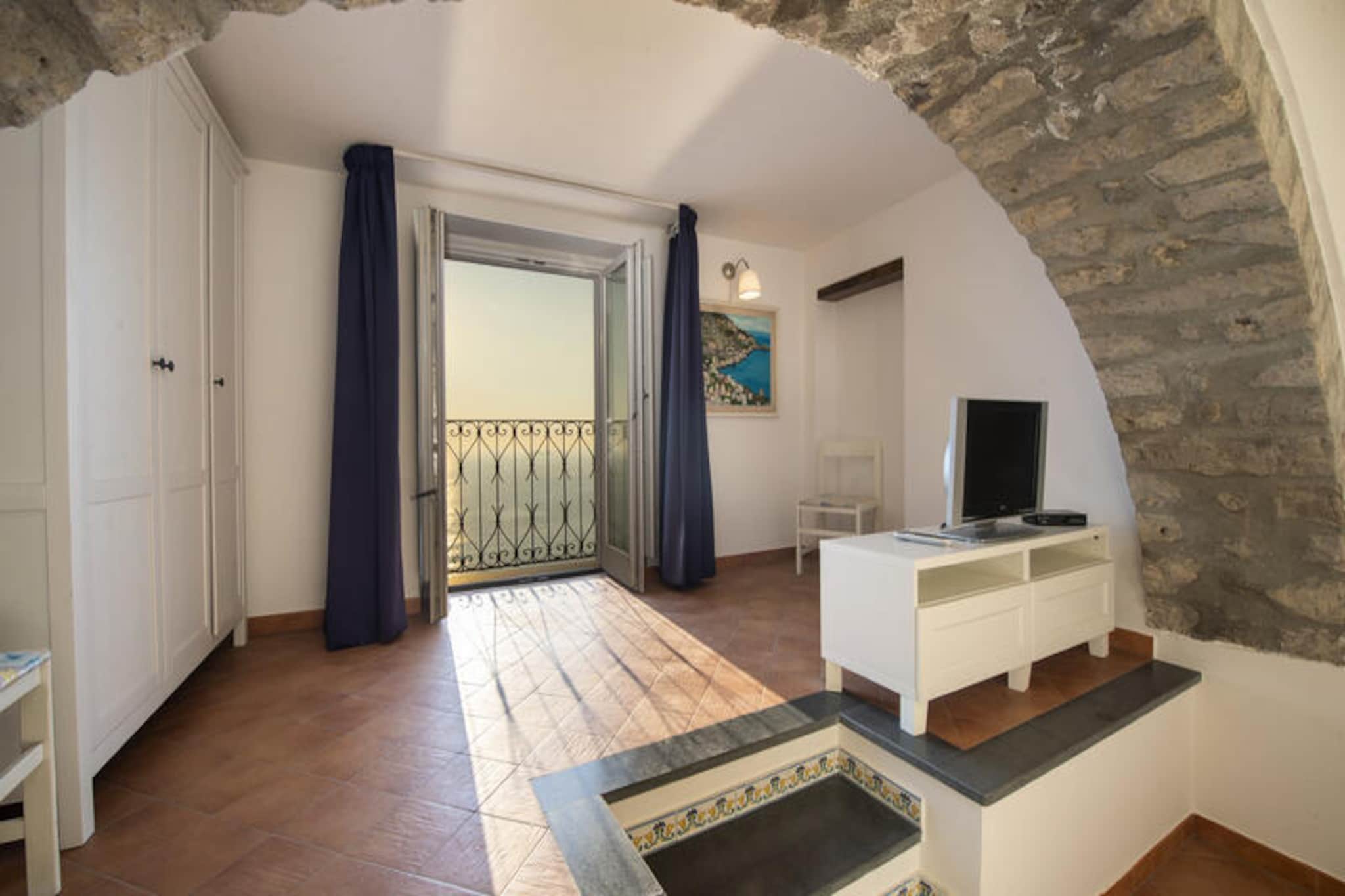 Perched in the serene upper reaches of Praiano, Casa Cimino A offers an enchanting retreat with sweeping views of Capri and Positano that will leave you breathless. This recently renovated gem captures the essence of the Amalfi Coast with its elegant furnishings and antique terracotta flooring, creating a warm and inviting atmosphere. Whether you're gazing out from the windows or enjoying the tranquility of the surroundings, this house is a haven of peace and beauty.
Spread across a single level, Casa Cimino A is thoughtfully designed for comfort and convenience. The living room features a cozy double sofa bed, while the fully equipped kitchen boasts stunning sea views and a dining table for four. The spacious double bedroom, complete with an en-suite bathroom, offers a private sanctuary with panoramic vistas. Two modern bathrooms with showers ensure a seamless stay for guests. Every corner of the house is imbued with charm and practicality, making it ideal for couples or small groups seeking a memorable escape.
Located just above the iconic Church of San Gennaro and near the famed Sentiero degli Dei trail, Casa Cimino A is perfectly positioned for exploring the wonders of Praiano. A short walk will take you to local bars, restaurants, and a small grocery store, while the nearby bus stops provide easy access to the surrounding Amalfi Coast treasures. For beach lovers, the One Fire Beach Club is just a 20-minute stroll away, offering sun-soaked relaxation by the sea.
Whether you're drawn to the breathtaking views, the rich cultural heritage, or the convenience of nearby amenities, Casa Cimino A promises an unforgettable Amalfi Coast experience. Let the charm of this idyllic retreat captivate your heart and create memories to cherish forever.