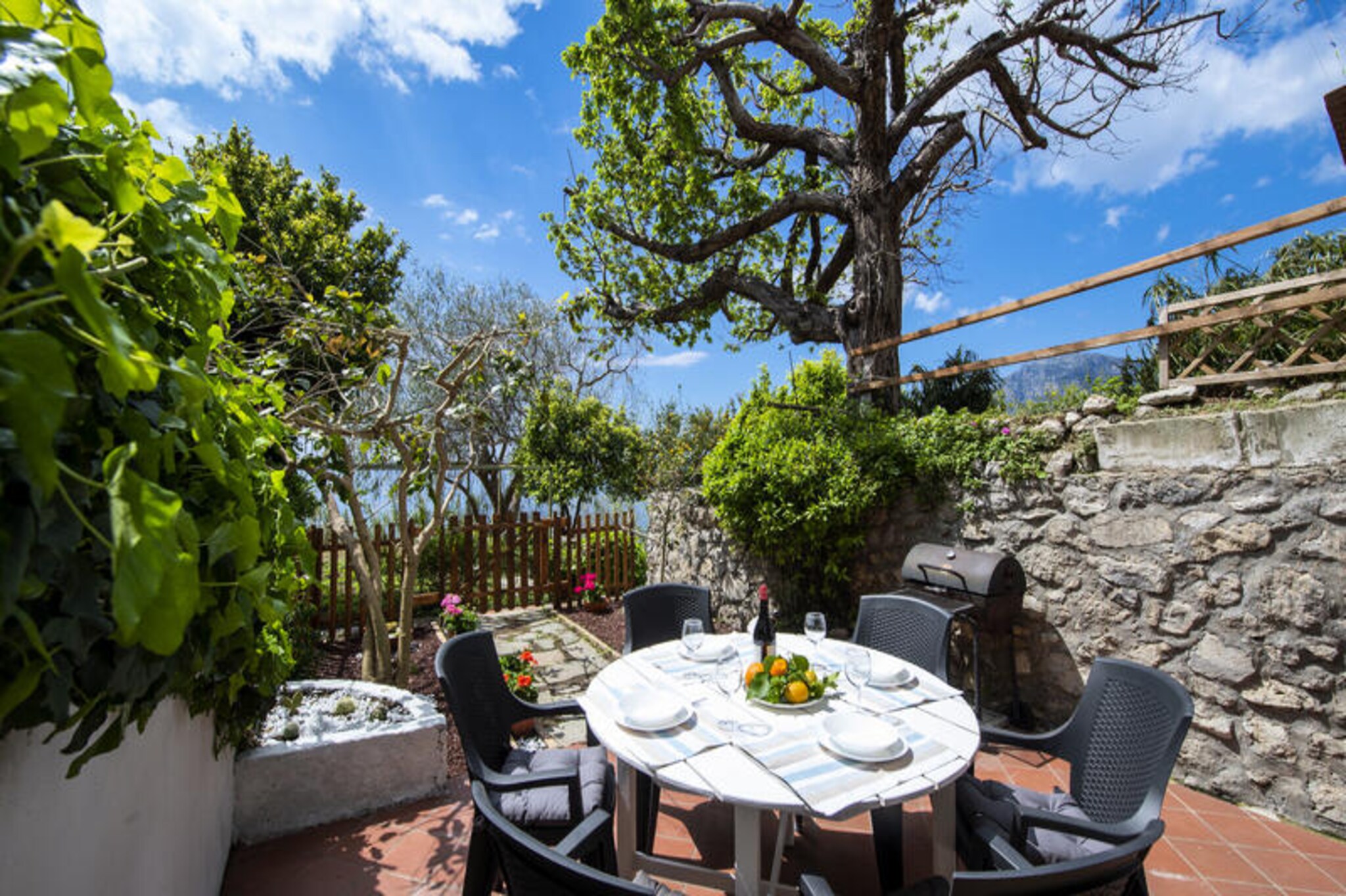 Perched on the western side of Praiano, Nonno Mario's House is a tranquil haven that captures the essence of the Amalfi Coast. With sweeping views of Positano and the enchanting island of Capri, this charming retreat invites you to immerse yourself in the region’s natural beauty. Whether you’re savoring a romantic escape or sharing unforgettable moments with friends, the panoramic terrace offers a front-row seat to breathtaking sunsets over the shimmering Mediterranean Sea. Recently renovated, the interiors blend modern comfort with timeless elegance, while the spacious garden with a barbecue area promises delightful al fresco dining experiences under the stars. \n\nSpread across three levels, the house is thoughtfully designed to ensure both privacy and convenience. The first level features a cozy living room with a sofa bed and a masonry kitchen, opening onto a garden with seating for six and a sea view. The mezzanine level boasts a double bedroom with a panoramic balcony, a bathroom with a shower, and a laundry room. On the third level, you’ll find two double bedrooms with direct access to the terrace, a fully equipped kitchen, and another bathroom with a shower. Every corner of the house is infused with charm, offering a serene retreat from the bustling world. \n\nPraiano’s village amenities are just a short walk away, including restaurants, bars, grocery stores, and the main beach, One Fire Beach Club. While the house doesn’t have private parking, a reserved paid parking area is available 800 meters away, ensuring peace of mind during your stay. Embrace the unique charm of Praiano’s pedestrian pathways, where steps lead you to hidden gems like the panoramic church of San Gennaro. \n\nWhether you’re exploring local trails, indulging in fresh Italian cuisine, or simply soaking up the coastal views, Nonno Mario's House offers an unforgettable gateway to the magic of the Amalfi Coast.