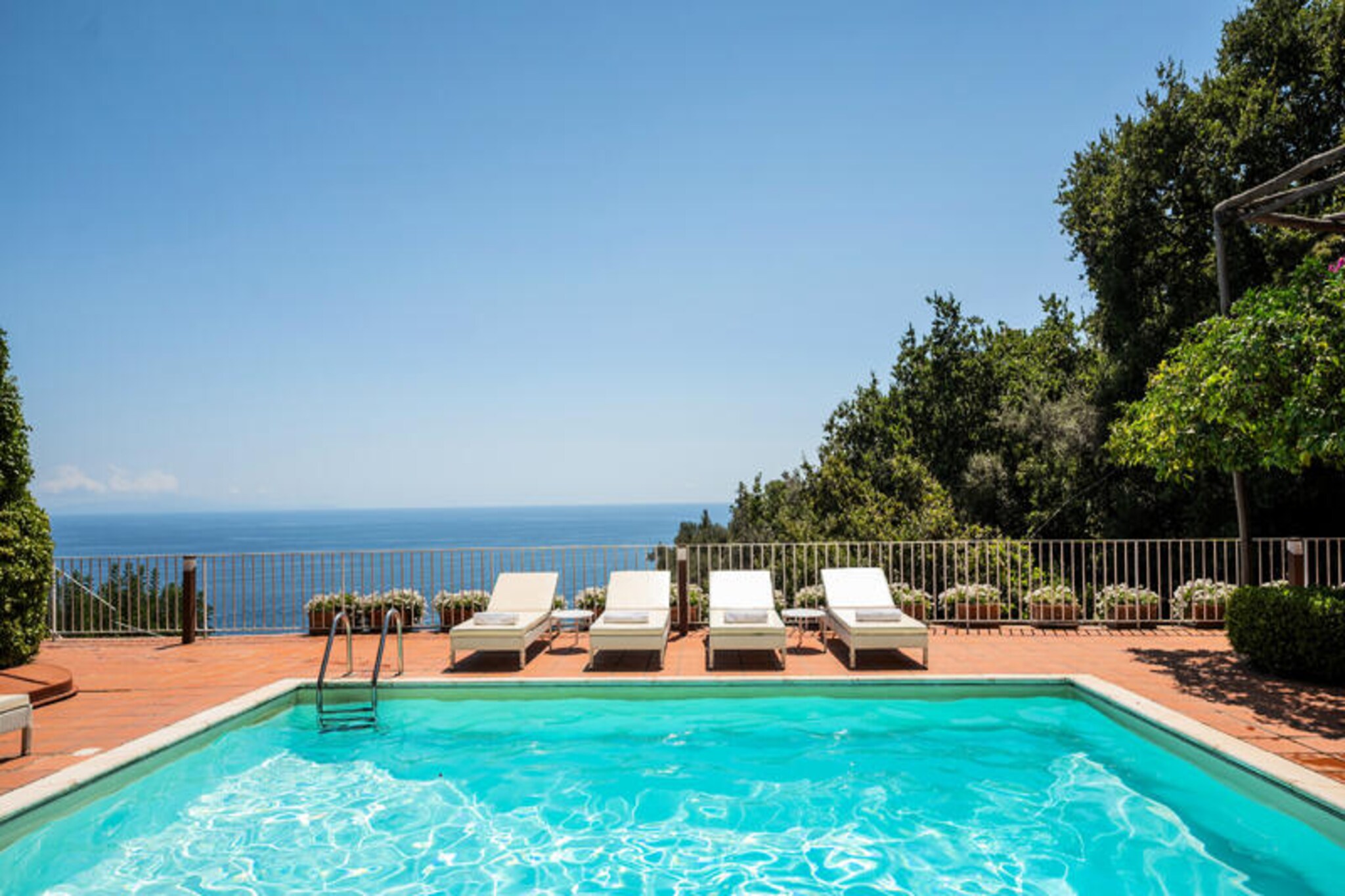 Perched along the iconic Amalfi Coast, Villa Bijoux offers a luxurious retreat where breathtaking sea views and lush greenery create an unforgettable setting. This exquisite villa is a haven of tranquility, blending Mediterranean charm with modern elegance. From its expansive terraces to its private swimming pool, every corner of Villa Bijoux invites you to relax and savor the beauty of the Italian coastline. Whether enjoying al fresco dining under the stars or lounging by the pool, the villa’s outdoor spaces are designed for indulgence and serenity.
The villa spans three levels, each thoughtfully designed to maximize comfort and style. The first level features two double bedrooms with en-suite bathrooms and direct access to a sea-view terrace. The main level boasts three additional double bedrooms, each with en-suite bathrooms and terrace access, along with two fully equipped kitchens and a computer area with Wi-Fi. On the upper floor, a luxurious double bedroom with a private terrace and en-suite bathroom with a jacuzzi awaits. The topmost level is home to a stunning outdoor pool, complete with sun loungers, showers, and a dining area for twelve.
Located just a few kilometers from the heart of Amalfi, Villa Bijoux is perfectly situated for exploring the region’s treasures. Santa Croce Beach is a short walk away, offering crystal-clear waters and charming seaside restaurants. The villa is also conveniently close to the Sita bus stop and several dining options, making it easy to immerse yourself in the local culture.
Whether you’re seeking a romantic getaway or a family escape, Villa Bijoux promises an unparalleled experience of luxury, comfort, and the timeless allure of the Amalfi Coast.