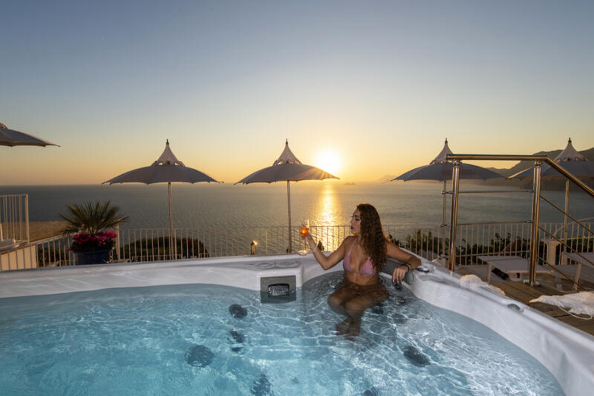 Perched on the western side of Praiano, Luxury Villa Malika offers an unparalleled retreat with breathtaking views of the Amalfi Coast and the islands of Capri and Positano. This recently renovated villa is a haven of tranquility, surrounded by lush gardens and expansive terraces that invite you to soak in the Mediterranean charm. Whether you’re enjoying the heated whirlpool at sunset or relaxing in the outdoor gym, every corner of this property is designed to provide serenity and luxury. The villa’s interiors are a perfect blend of modern sophistication and Mediterranean elegance, with refined furnishings and calming hues that echo the beauty of the surrounding landscape. Free Wi-Fi and concierge services ensure a seamless stay, while butler services during the summer elevate the experience further.  
      
      Spread across two levels, the villa boasts a spacious main floor with a panoramic terrace furnished for al fresco dining, a sea-view living room with SMART TV and stereo system, and a fully equipped kitchen featuring top-of-the-line appliances. The lower floor offers direct access to cultivated gardens and includes two luxurious bedrooms, each with private bathrooms and stunning sea views. The main bedroom on the upper floor also provides a private sanctuary with its king-size bed and en-suite bathroom.  
      
      Located just steps from the heart of Praiano, the villa is easily accessible via a picturesque path and offers porterage services for convenience. Nearby, you’ll find charming local bars, restaurants, and grocery stores, as well as access to the famous Path of the Gods and public transportation for exploring the Amalfi Coast. Whether you’re seeking adventure or relaxation, Luxury Villa Malika is the perfect base for an unforgettable Italian getaway.  
      
      From sunrise to sunset, let the beauty of the Amalfi Coast surround you in this exquisite villa, where every moment becomes a cherished memory.