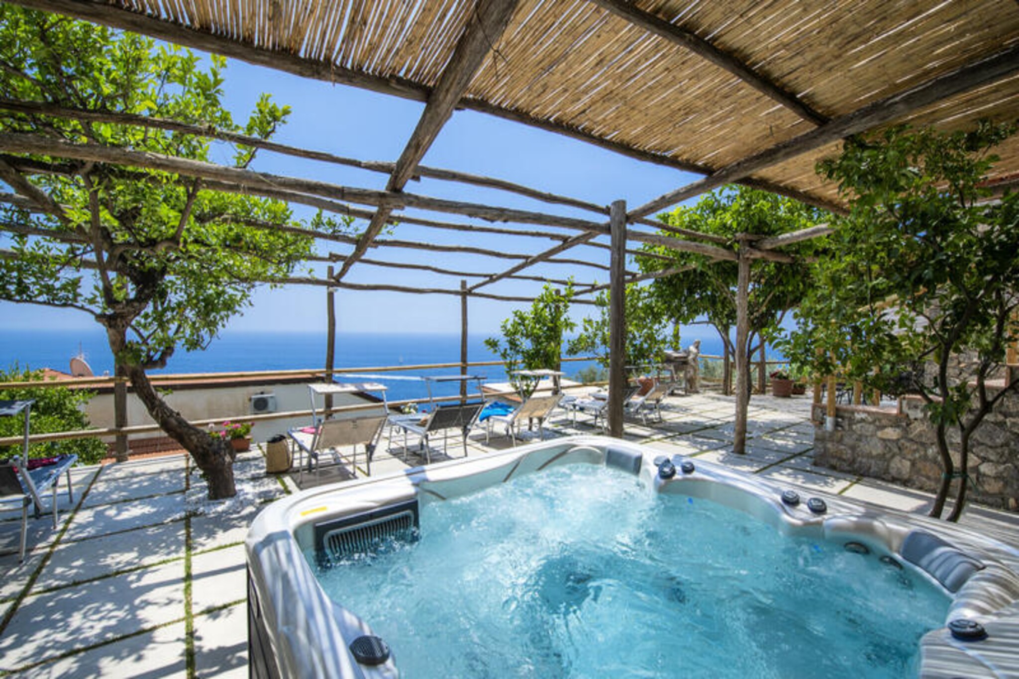 Perched on the eastern side of Praiano, Casa Il Riccio offers a quintessential Mediterranean escape with breathtaking sea views and a serene atmosphere. This finely restored villa exudes charm with its traditional barrel vaults and lush garden shaded by a fragrant lemon pergola. The outdoor space is a haven for relaxation, featuring a heated solarium with a hydromassage pool, a barbecue area, and an alfresco dining table where you can savor the beauty of the Amalfi Coast. Whether you're soaking in the jacuzzi or enjoying the panoramic vistas, every moment here feels like a dream.  
                      Designed to accommodate up to six guests, Casa Il Riccio is spread across two independent floors, ensuring privacy and comfort for all. The upper floor boasts a spacious suite with an induction cooktop, a cozy sitting area, and a bathroom with a bathtub. The lower floor features two elegant double bedrooms, each with an en-suite bathroom, and a kitchenette. Air conditioning and Wi-Fi are available throughout, ensuring modern convenience amidst timeless beauty.  
                      The villa's location is truly privileged, just steps away from local restaurants, bars, a grocery store, and the beach. A short walk leads you to Praiano's main beach, La Praia, or the nearby bus stops, making it easy to explore the stunning Amalfi Coast. For added convenience, luggage service and private parking are available upon request.  
                      Casa Il Riccio is more than just a holiday home—it's an invitation to immerse yourself in the enchanting allure of the Amalfi Coast, where every detail has been designed to create unforgettable memories.