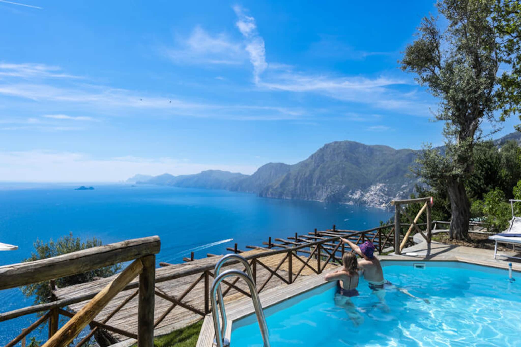 High above the shimmering Amalfi Coast, Casa Punta di Diamante offers a serene escape where the beauty of nature meets Mediterranean elegance. Perched at the highest point of Praiano, this exquisite property is a haven for those seeking tranquility and breathtaking views. From the moment you ascend the 210 steps to reach this gem, you’ll be rewarded with unparalleled panoramas of Capri, Positano, and the endless blue of the Tyrrhenian Sea. The peaceful atmosphere and the proximity to the famous Path of the Gods make it a dream retreat for nature lovers and adventurers alike.
The house is designed to provide both comfort and style, with three spacious bedrooms, each offering access to private balconies or terraces with stunning sea views. The open-plan living and dining area is bright and inviting, leading to a fully equipped kitchen perfect for preparing meals to enjoy al fresco. The outdoor spaces are truly the highlight: a 200-square-meter landscaped garden, complete with an outdoor kitchen, a private swimming pool, and a solarium area, invites you to relax under the sun or dine under the stars. Modern amenities such as Wi-Fi, air conditioning, and heating ensure a comfortable stay year-round.
Praiano’s charm lies in its authentic, untouched beauty, and Casa Punta di Diamante immerses you in this unique atmosphere. Within walking distance, you’ll find local restaurants, shops, and a bus stop, all accessible via the characteristic stairways of this picturesque village. The Path of the Gods, one of Italy’s most renowned hiking trails, begins just steps from the property, offering unforgettable adventures through the dramatic coastal landscape.
Whether you’re savoring a sunset from the panoramic terrace or exploring the vibrant Amalfi Coast, Casa Punta di Diamante promises an unforgettable Italian getaway. Please note: due to its elevated location and numerous steps, this property is best suited for active guests who appreciate the rewards of a secluded retreat.