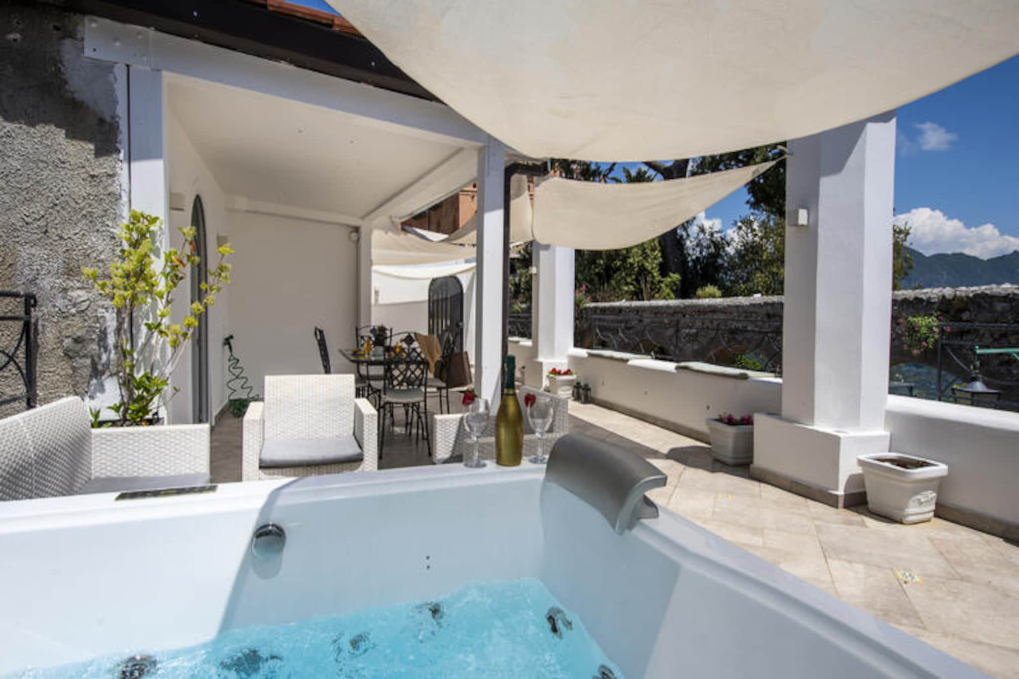 The romantic residence "Le Suites della Principessa", in the heart of Ravello, is just 100 meters from the Duomo and Villa Rufolo. It represents the ideal solution for those who wish to fully enjoy the lively Amalfi Coast during the day, then take refuge in the evening in one of the most elegant and refined locations in the area. Recently renovated and meticulously maintained, the apartment features a large terrace overlooking the enchanting Belvedere Gardens of the Princess of Piedmont, one of the main attractions of the place, among whose arches from the early 1900s, it is possible to find the blue sea meeting the sky. The terrace has a solarium area, enriched with comfortable sun loungers, a fine Vietri ceramic table, and a hydromassage pool. The refined and bright interior is arranged on a single level with a large, fully equipped kitchen opening onto the terrace, two double bedrooms, and two bathrooms with showers, connected by a long hallway decorated with lively ceramic details. Air conditioning and free Wi-Fi are available throughout.
The apartment is arranged on one floor.
• Mediterranean-style terrace with sea view, solarium, and hydromassage pool;
• 2 double suites with windows overlooking the Belvedere;
• 2 bathrooms with showers in Vietri ceramic tiles;
• Large, fully equipped kitchen with oven, dishwasher, and washing machine.
"Le Suites della Principessa" is located in a historic residence in the center of Ravello, facing the Belvedere of the Princess of Piedmont. The apartment is accessed via about twenty steps from the entrance, located along the municipal road. The latter is easily accessible on foot from Piazza San Giovanni del Toro, where it is possible to arrive by car via the communication or, alternatively, from the side steps of Piazza Duomo.
It is possible to reserve independent parking about 1.5 km from the property with a shuttle service.
A few steps from the structure there are:
• Villa Rufolo (150 meters)
• Villa Cimbrone (650 meters)
• Vallée des Ferrières (1.8 km)
• Bars and restaurants
• Local bus (2 km)
• Langella grocery store (500 meters)