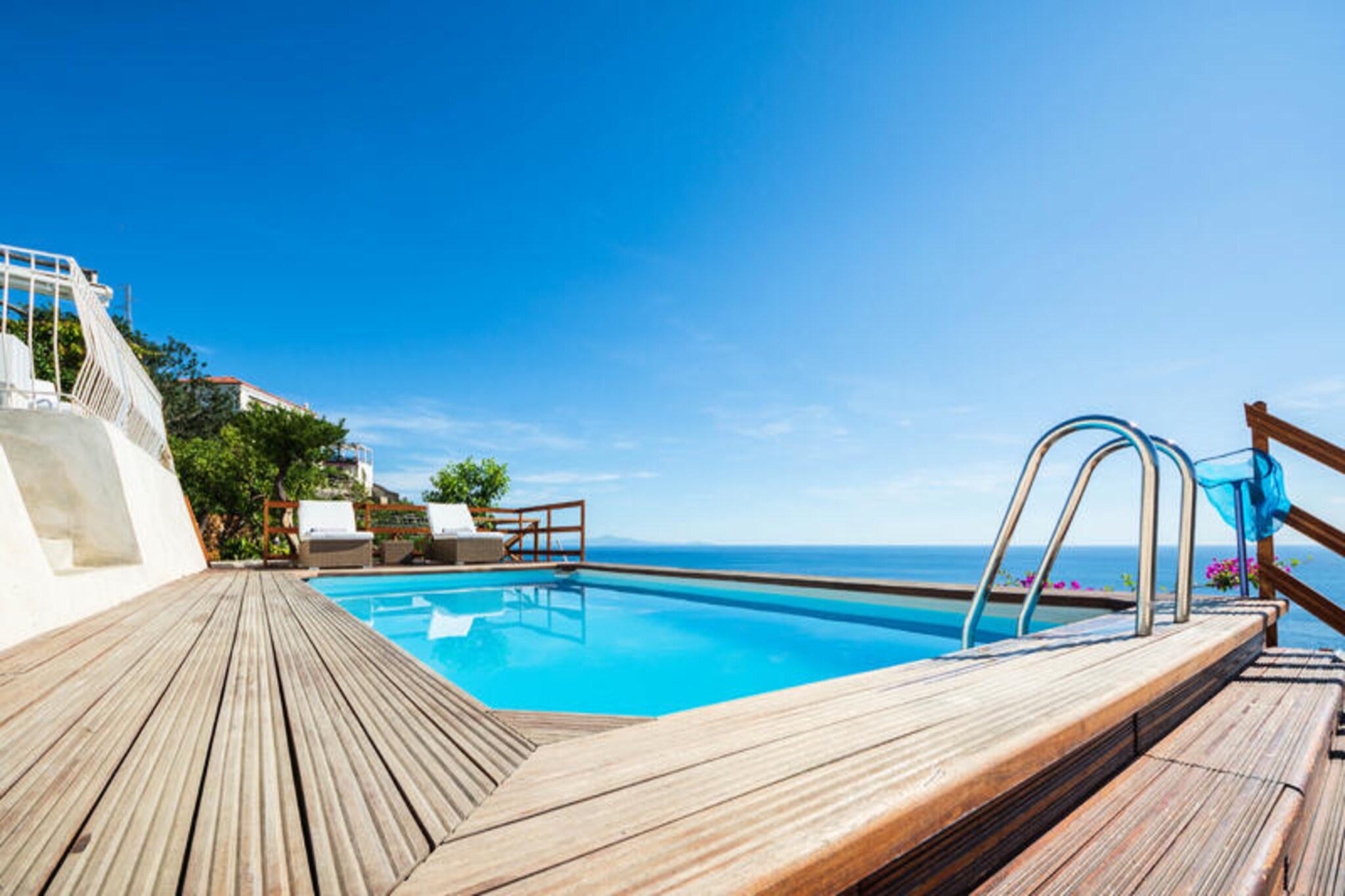 Perched above the sparkling Amalfi Coast, Villa Vittoria offers a luxurious retreat where Mediterranean elegance meets breathtaking sea views. Just steps from the charming town of Maiori, this recently renovated villa is surrounded by lush gardens, a solarium, and a panoramic swimming pool. Imagine soaking in the heated jacuzzi as the sun sets over the Tyrrhenian Sea, creating unforgettable moments of relaxation and romance. Accessible via approximately 90 steps from the private parking area, the villa’s elevated position ensures privacy and stunning vistas at every turn.
The villa’s refined interiors span two levels, blending modern comfort with timeless Italian charm. The main floor features a spacious sea-view living room that opens onto a terrace adorned with a handcrafted Vietri ceramic dining table, perfect for al fresco meals. A fully equipped kitchen, two double bedrooms (one with sea views), and a bathroom with a spa/chromotherapy shower complete the ground floor. Upstairs, the mezzanine level boasts two additional double bedrooms, each with an en-suite bathroom, and one offering mesmerizing sea views. Air conditioning and free Wi-Fi are available throughout, ensuring a comfortable stay for up to eight guests.
Outside, the multi-level terraces invite you to unwind in style. From the garden lounge to the solarium and the panoramic pool, every corner is designed for relaxation. The villa’s proximity to Maiori means you’re just a short walk from its vibrant promenade, local restaurants, and the secluded Acqua Chiara beach, accessible via 160 steps. Whether you’re exploring the Amalfi Coast or simply enjoying the villa’s luxurious amenities, Villa Vittoria promises a stay filled with beauty, comfort, and unforgettable memories.