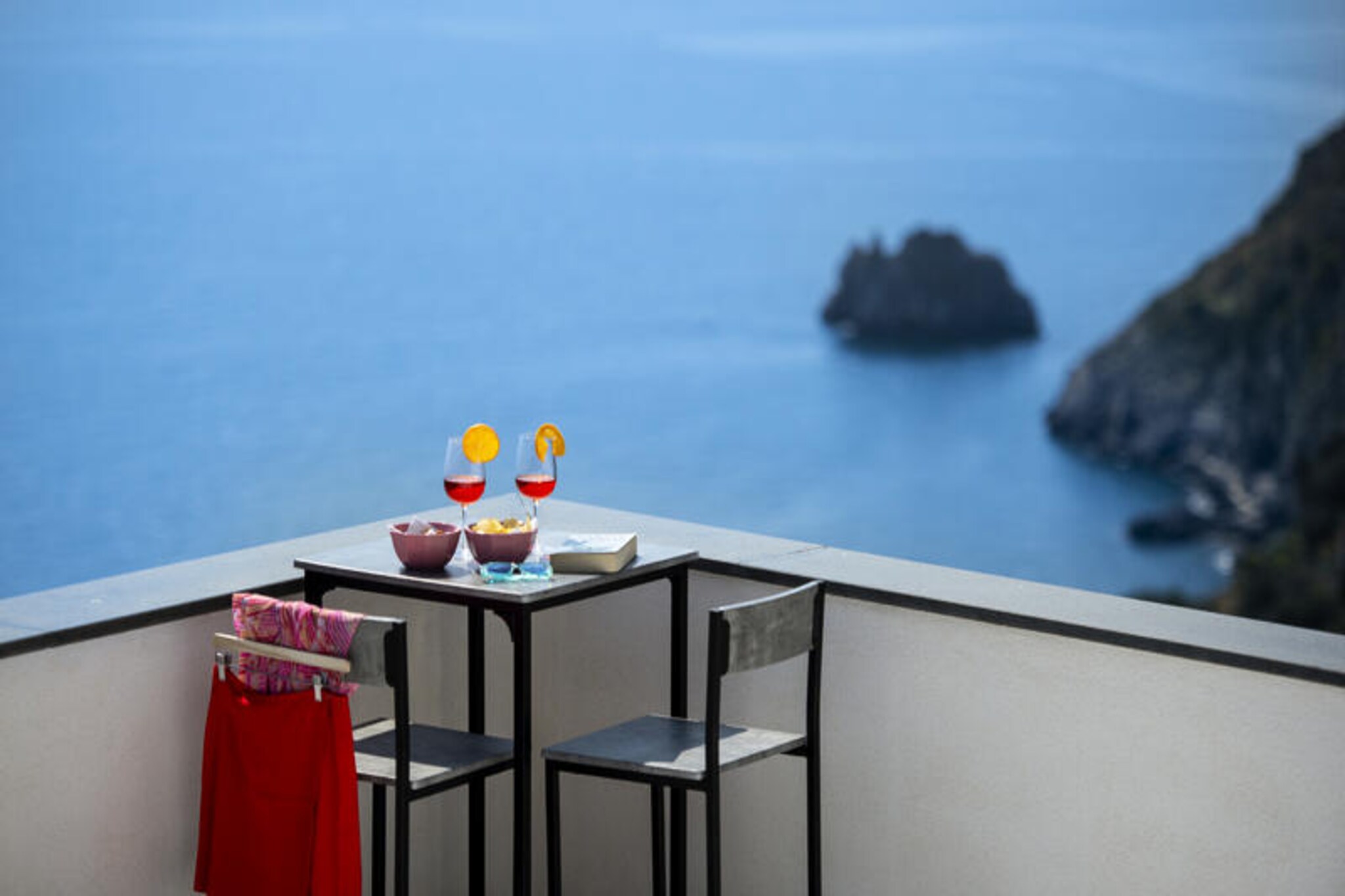 Perched high above the shimmering Amalfi Coast, Casa Madonna del Mare offers a serene escape where the charm of a traditional fisherman’s cottage meets modern elegance. From the moment you step inside, you’ll be captivated by the breathtaking sea views that flood the Mediterranean-style living room through its expansive window. This lovingly restored home, nestled into the rock, exudes warmth and character, with thoughtful details and soft lighting creating a welcoming atmosphere for families and couples alike.
The house spans two levels, offering ample space and comfort. On the main floor, the living room features a sofa bed, a dining table for six, and a small balcony where you can soak in the coastal beauty. The open-plan kitchen is fully equipped for preparing delicious meals, while the double bedroom with sea views and two modern bathrooms, one with a laundry area, ensure convenience. Upstairs, the mezzanine levels provide additional sleeping areas, including a cozy room with a French bed and another with a single bed and access to a stunning terrace. Here, you can unwind with a drink al fresco, surrounded by the endless blue of the sea.
Located on the peaceful eastern side of Praiano, the villa is a tranquil retreat yet close to local amenities. Within walking distance, you’ll find a grocery store, several restaurants, and the picturesque La Praia beach, just an 8-minute stroll away. The house is accessible via 150 steps, adding to its secluded charm, and private parking is available upon request. For those arriving without a car, the nearby bus stops provide easy access to explore the Amalfi Coast.
Whether you’re savoring the panoramic views, enjoying the comforts of this beautifully designed home, or discovering the enchanting surroundings, Casa Madonna del Mare promises an unforgettable Italian getaway.