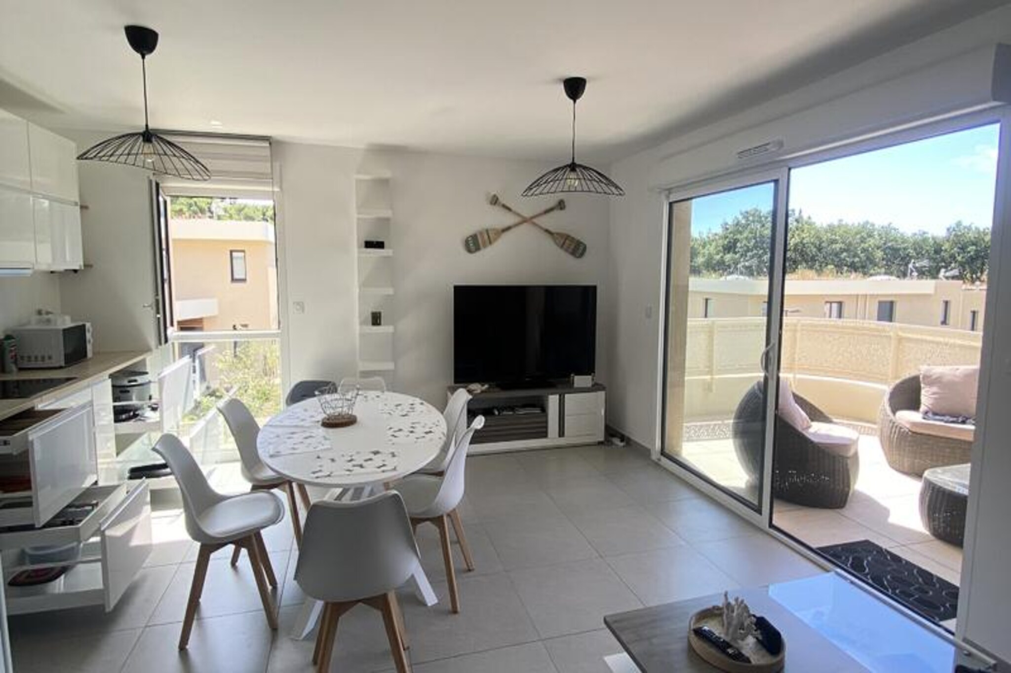 Imagine waking up to the gentle sound of waves and stepping out onto your southeast-facing terrace to soak in the morning sun. This charming seaside apartment, located in the heart of the town, offers a perfect blend of comfort and convenience for your next getaway. With direct access to the sea and all amenities within walking distance, it’s an ideal retreat for families or friends seeking a coastal escape. The apartment’s modern design and thoughtful layout create a welcoming atmosphere that feels like a home away from home.
Inside, you’ll find a bright living room with a cozy sofa bed, perfect for relaxing after a day of exploring. The open-plan kitchen and dining area are fully equipped, making it easy to prepare meals and enjoy them together around the table. Two comfortable bedrooms, one with a double bed and the other with two single beds, ensure restful nights for up to six guests. The bathroom features a modern shower and WC, while the covered parking space adds extra convenience for those traveling by car.
Step outside and discover the vibrant town center with its charming shops, local markets, and delightful restaurants, all just a short stroll away. For beach lovers, the direct access to the sea means you can enjoy the golden sands and crystal-clear waters at any time. Whether you’re looking to unwind by the shore, explore nearby attractions, or indulge in local cuisine, this apartment places you in the heart of it all.
Treat yourself to a stay at this beautifully renovated property, part of the Maeva Home Prestige collection, and create unforgettable memories by the sea.