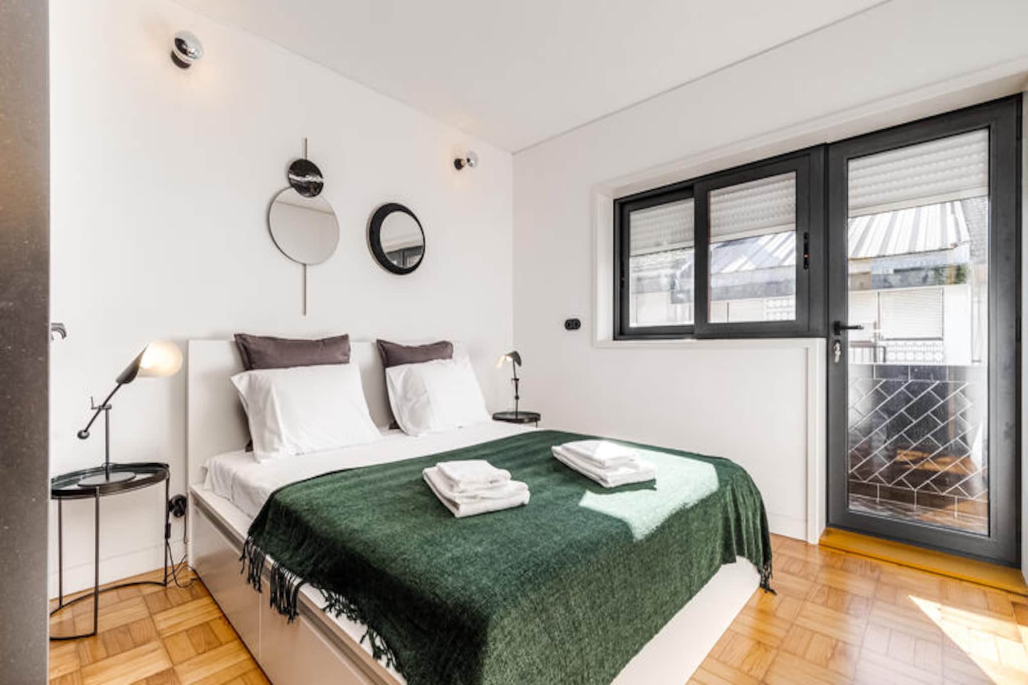 In the heart of Vila Nova de Gaia, where the charm of the Douro River meets the vibrancy of city life, this elegant apartment offers a serene escape for travelers seeking both comfort and convenience. Imagine waking up to the gentle hum of the city, just moments away from the iconic Jardim do Morro, and stepping into a world of cultural and natural beauty. With its prime location, this residence is a gateway to the best of northern Portugal. \n\nThe apartment, spanning 80 m², is tastefully furnished with modern touches that exude sophistication. It features two cozy bedrooms, comfortably accommodating up to four guests, making it ideal for families or small groups. The open-plan kitchen is fully equipped with high-end appliances, including an induction hob, dishwasher, and coffee maker, ensuring you have everything you need for a delightful stay. Additional amenities such as Wi-Fi, satellite TV, electric heating, and a washing machine add to the convenience, while thoughtful details like a hair dryer and iron make it feel like a home away from home.\n\nStep outside, and you’ll find yourself immersed in the vibrant life of Vila Nova de Gaia. The famous Jardim do Morro park and metro station are just a short stroll away, offering breathtaking views of Porto and the Douro River. For culinary enthusiasts, the renowned Yeatman restaurant is within easy reach, while the nearby Mini Preço supermarket ensures you have all the essentials. Nature lovers can explore the sandy shores of Praia dos Lavadores or the lush trails of Parque Biológico de Gaia, both just a short drive away.\n\nWhether you’re here to explore the historic streets of Porto, relax by the river, or indulge in the region’s world-famous wines, this apartment provides the perfect base for an unforgettable Portuguese getaway. Let the charm of Vila Nova de Gaia captivate you as you create lasting memories in this exceptional retreat.