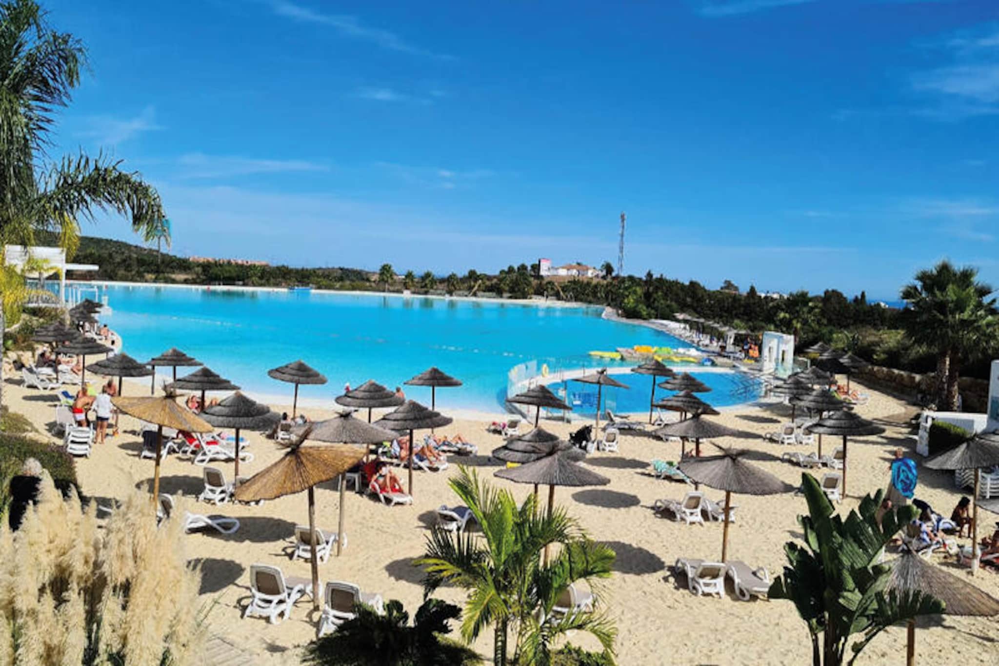 Imagine waking up to the serene beauty of Europe’s first Crystal Lagoon, a shimmering oasis nestled within the lush tropical gardens of Alcazaba Lagoon in Casares, Spain. This exclusive residential complex offers a tranquil escape on the Costa del Sol, blending modern Mediterranean architecture with unparalleled resort amenities. Whether you’re seeking relaxation or adventure, this destination promises an unforgettable experience under the Andalusian sun. \n\nThis stylish one-bedroom apartment is thoughtfully designed for ultimate comfort and privacy, accommodating up to two guests. With elevator access, a private terrace and garden, and air conditioning, every detail has been crafted to enhance your stay. The fully equipped kitchen features premium appliances, including a Nespresso machine, while high-speed Wi-Fi and a Smart TV with international channels ensure you stay connected and entertained. Guests can also enjoy shared facilities such as a swimming pool, paddling pool, and children’s play area, making it ideal for couples or small families. \n\nJust steps away, the Crystal Lagoon invites you to indulge in water sports like kayaking and paddleboarding or simply unwind on the private sandy beach. The on-site Mediterranean restaurant offers delicious cuisine, while nearby Estepona Golf and other prestigious courses cater to golf enthusiasts. For those eager to explore, Estepona’s sandy beaches and vibrant town center are only a short drive away, offering local boutiques, traditional tapas bars, and seaside chiringuitos. \n\nWhether you’re here for the lagoon’s tranquility, the region’s world-class golf courses, or the charm of Andalusian culture, Alcazaba Lagoon is the perfect base for your Costa del Sol getaway. Book now and immerse yourself in a unique blend of luxury, nature, and adventure.