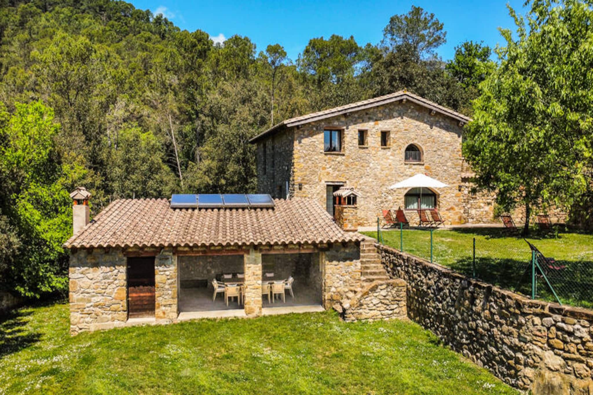 In the heart of the serene La Garrotxa region, Majordoms Molí offers a unique escape where history and nature blend seamlessly. This beautifully restored Catalan mill, nestled amidst rolling hills and lush greenery, is the perfect retreat for families and friends seeking tranquility and authenticity. Imagine waking up to the gentle sounds of nature, with the medieval charm of Besalú and the breathtaking landscapes of the La Garrotxa Volcanic Zone Natural Park just a short drive away.
The property boasts a private pool surrounded by sun loungers, a 3,000 m² garden, and a covered terrace with a barbecue and dining area, inviting you to savor the Mediterranean lifestyle. Inside, the house exudes charm and comfort across three levels. The ground floor features a spacious dining room, a fully equipped kitchen, and a cozy living area. The lower floor houses a master suite with direct garden access, while the first floor offers three double bedrooms, each with private bathrooms, ceiling fans, and blackout curtains for restful nights. Thoughtful details like high-quality linens, eco-friendly toiletries, and smart thermostats ensure a comfortable stay.
Majordoms Molí is ideally located for exploring the region. Discover the medieval village of Besalú with its iconic Romanesque bridge and vibrant markets, or venture into the La Garrotxa Volcanic Zone for hiking and cycling through beech forests and volcanic landscapes. The Mare de Déu del Mont Sanctuary offers panoramic views of the Pyrenees, while the Costa Brava beaches are just an hour's drive away.
Whether you’re seeking adventure or relaxation, Majordoms Molí provides an idyllic setting to create unforgettable memories in the heart of Catalonia.