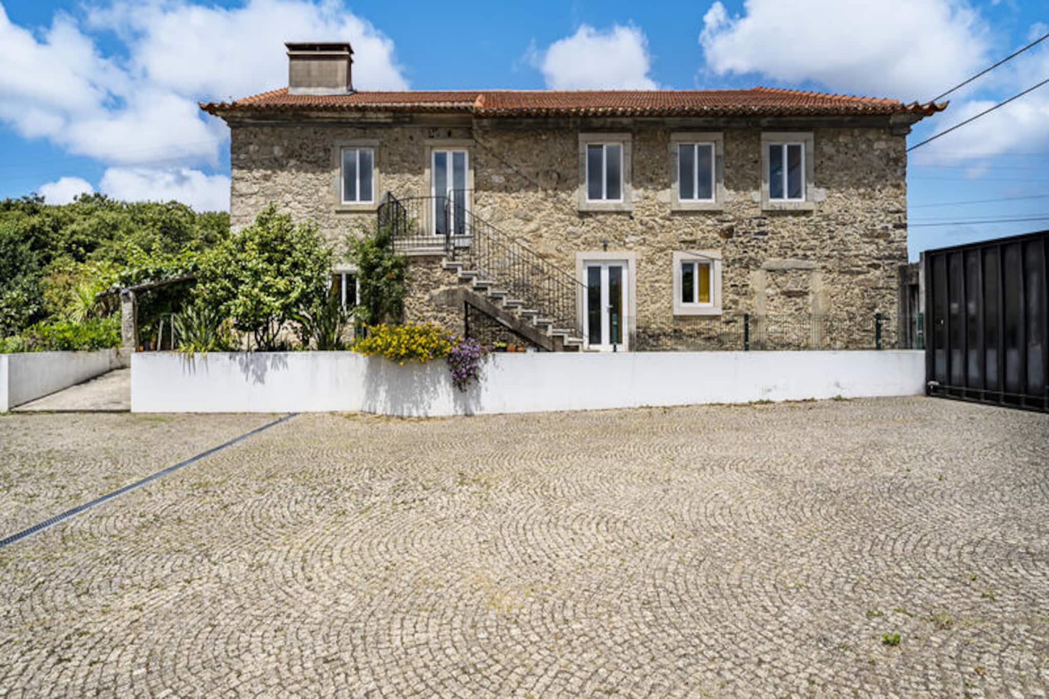 In the heart of Santa Maria da Feira, this charming villa offers a tranquil retreat surrounded by lush greenery and a serene rural atmosphere. With its bright and spacious interiors, this 200 m² property is the perfect getaway for families or groups of up to eight guests seeking comfort and relaxation. Imagine waking up to the soothing views of the garden, enjoying breakfast on the expansive 200 m² terrace, and planning a day filled with exploration and leisure. \n\nThe villa features four beautifully appointed bedrooms, ensuring restful nights for everyone. The fully equipped kitchen, complete with an induction cooktop, refrigerator, oven, microwave, and dishwasher, invites you to prepare delicious meals with ease. Modern amenities such as Wi-Fi, satellite TV with multilingual channels, a washing machine, dryer, and a barbecue make your stay as convenient as it is enjoyable. The outdoor space, with its garden furniture and fenced area, is ideal for unwinding in the fresh Portuguese air. \n\nLocated just 1 km from the historic Castelo de Santa Maria da Feira and a variety of local restaurants, the villa is perfectly situated for exploring the region. The sandy beaches of Furadouro and Torreira are only a short drive away, offering sun-soaked days by the sea. For nature enthusiasts, the nearby S. Jacinto and Ria de Aveiro natural parks provide breathtaking landscapes and opportunities for outdoor adventures. Golf lovers will appreciate the proximity to Miramar Golf Course, just 20 km away. \n\nWhether you’re drawn to the cultural richness of Santa Maria da Feira, the pristine beaches, or the natural beauty of the surrounding parks, this villa is your gateway to an unforgettable Portuguese escape. Relax, explore, and create lasting memories in this idyllic setting.