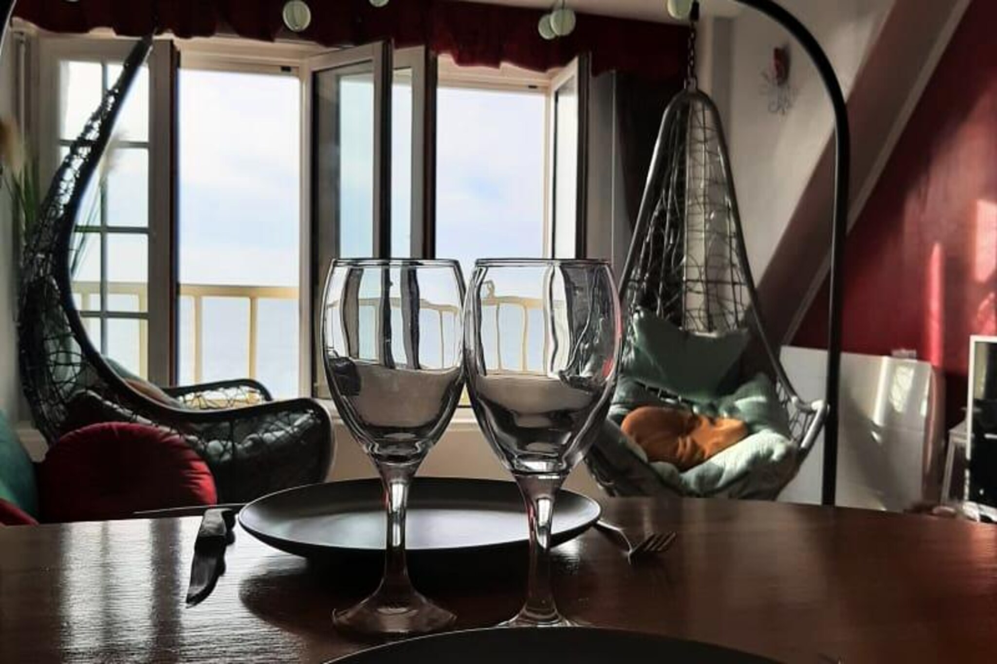 Imagine waking up to the soothing sound of waves and the sight of the sea stretching endlessly before you. This charming seaside apartment, rated as a 2-star furnished tourist accommodation, offers the perfect romantic getaway or peaceful retreat. Perched on the 4th floor, it rewards you with an exceptional panorama of the lighthouse, the shimmering sea, and the dramatic cliffs of the coast—a view that makes every step of the climb worthwhile. Here, serenity and the art of living come together to create unforgettable memories. 

Inside, the apartment is thoughtfully designed for comfort and relaxation. The cozy living room invites you to unwind with your favorite shows on TV, while the fully equipped kitchen and dining area set the stage for intimate dinners. The modern bathroom adds a touch of convenience, and the carefully decorated bedroom, with its plush double bed and gentle coastal ambiance, ensures restful nights. A small desk corner provides a quiet space for writing postcards or catching up on work. For a touch of romance, settle into the hanging love seats on the balcony and let the breathtaking views enchant you. 

Located in the heart of Tréport, this apartment places you within easy reach of the town’s vibrant charm. Stroll along the esplanade, explore local shops, or savor fresh seafood at nearby restaurants. Please note that during summer and weekends, the esplanade is closed to traffic from 11 a.m. to 10 p.m., ensuring a peaceful pedestrian-friendly atmosphere. 

Whether you’re seeking a tranquil escape or a romantic seaside adventure, this apartment is your perfect haven. Book your stay and let the beauty of the French coast captivate you.