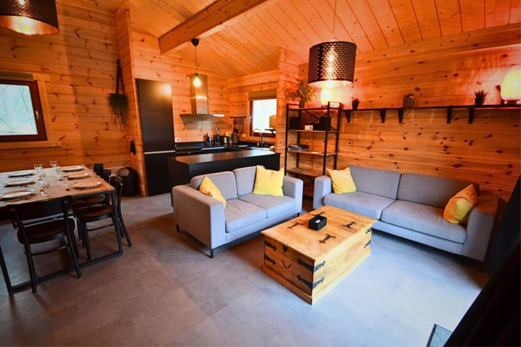 Nestled in the picturesque setting of Oignies-en-Thierache, part of the beautiful Viroinval in the Namur region of Belgium, this inviting chalet offers a perfect retreat. Located on Rue du Village de Vacances, the site provides a tranquil base for exploring the Ardennes forest and the natural beauty of the area. This cozy chalet is designed for comfort and convenience, accommodating guests with a host of amenities tailored for a self-catered stay.

The communal areas are designed for socialising and relaxation. The main Living room features a comfortable seating area and a TV for entertainment. The adjacent Kitchen is exceptionally well-equipped, catering to all your cooking needs with a comprehensive set of appliances. These include an electric kettle, toaster, combination microwave, and both a fridge and freezer. Coffee enthusiasts have options with both a filter/pad coffee machine and an espresso machine. Crucially, a dishwasher is included, making clean-up effortless. Sleeping arrangements are flexible and comfortable across three separate bedrooms. The main bedroom has a double bed and a TV, while the second bedroom also features a double bed. The third bedroom is ideal for children or a small group, offering two single beds and a bunk bed.

The chalet includes a clean and functional bathroom with a shower. Additional practical features include complimentary Internet access throughout the property and essential heating to ensure a comfortable stay in any season. Outdoor living is a highlight, with a balcony or terrace provided, along with two sets of garden furniture for enjoying meals or simply relaxing outdoors.