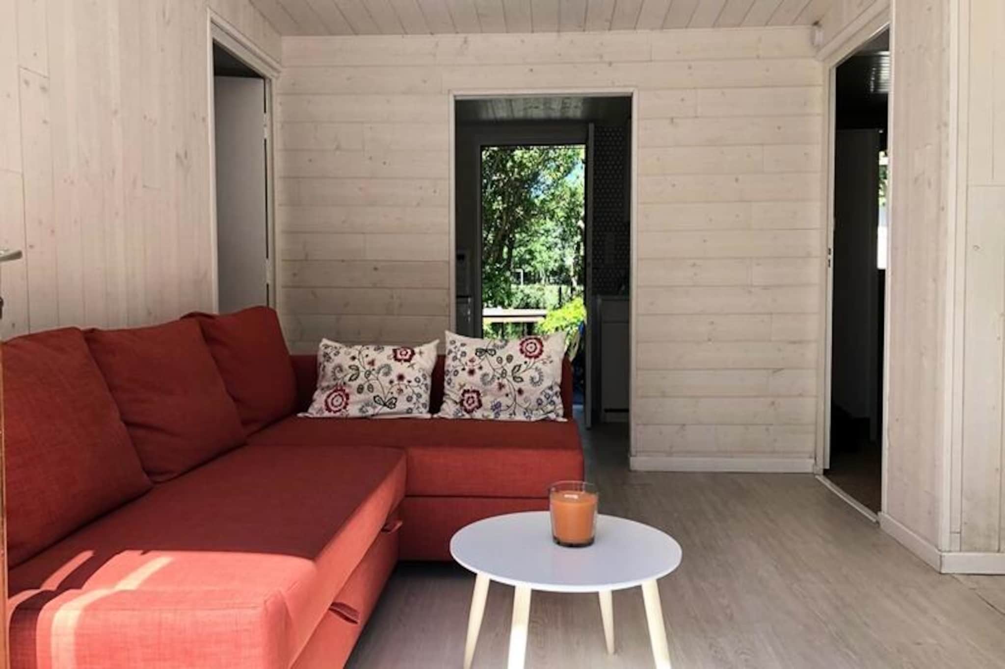 Amidst the serene charm of southwestern France, this delightful chalet offers a tranquil retreat surrounded by lush greenery and the gentle hum of nature. Imagine mornings spent sipping coffee on the outdoor terrace, with sunlight filtering through the trees and the promise of a relaxing day ahead. Whether you’re seeking a peaceful escape or a base to explore the region’s treasures, this property welcomes you with warmth and comfort. \n\nInside, the chalet boasts a thoughtfully designed layout to ensure a comfortable stay. The fully equipped kitchen invites you to prepare meals just like at home, while the bright living and dining area creates a cozy space for gathering with loved ones. The first bedroom features a 140 cm double bed, perfect for restful nights, while the second bedroom offers two 90 cm single beds, ideal for children or friends. A modern bathroom with a toilet completes the interior amenities. Step directly from the kitchen onto the terrace, where outdoor meals and moments of relaxation await. \n\nThe enclosed, tree-lined garden is a highlight, offering a safe haven for children to play freely and a serene setting for unwinding under the open sky. Additional conveniences include access to a garage with a washing machine and on-site parking, ensuring a hassle-free stay. \n\nLocated in a region known for its natural beauty and cultural richness, this chalet is your gateway to unforgettable experiences. Whether exploring nearby vineyards, enjoying coastal adventures, or simply basking in the tranquility of the garden, this property promises memories that will linger long after your stay.