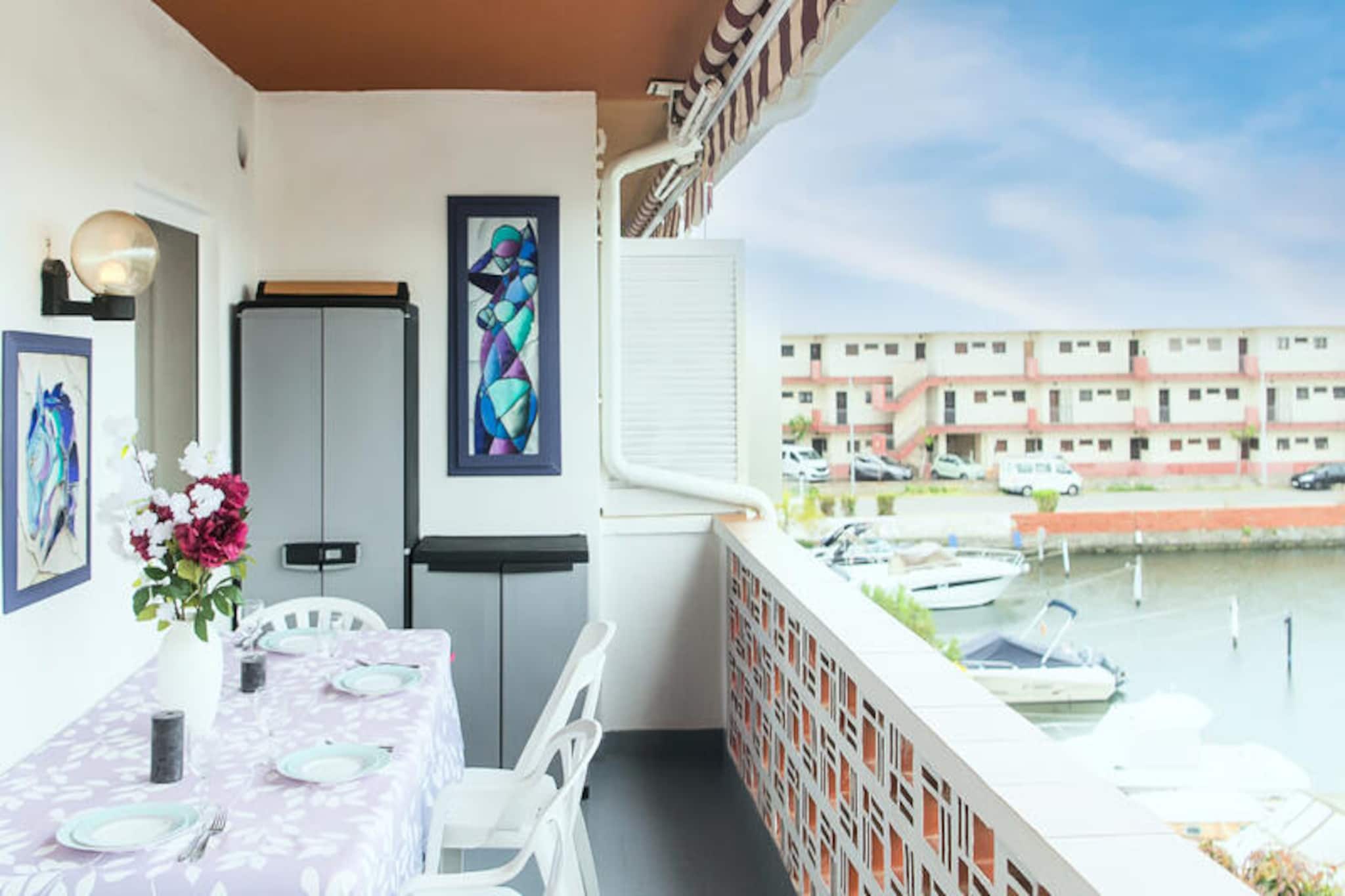 In the heart of the enchanting town of Empuriabrava, where picturesque canals weave through a vibrant Mediterranean atmosphere, this 56 m² apartment offers a delightful retreat for up to six guests. Whether you're planning a family getaway or a relaxing holiday with friends, this charming residence invites you to experience the unique charm of Spain's 'Venice of the Costa Brava.' From the moment you step inside, you'll be greeted by a bright and airy living space, where large panoramic windows frame stunning views of the tranquil canals. The adjoining terrace is the perfect spot to unwind with a morning coffee or an evening glass of wine, soaking in the serene surroundings.
The apartment is thoughtfully designed for comfort and convenience. The living room features a cozy double sofa bed and a dining area ideal for shared meals or lively conversations. The open-plan kitchen is fully equipped with modern appliances, making it easy to prepare everything from quick breakfasts to gourmet dinners. Two inviting bedrooms provide restful havens: a master bedroom with a plush double bed and a second bedroom with two single beds, ensuring a comfortable stay for all. A sleek bathroom with a shower and an additional toilet add to the practicality of this charming home away from home.
Step outside, and you'll find yourself immersed in the lively energy of Empuriabrava. Stroll along the canals, explore the nearby cafés and restaurants, or take a leisurely 20-minute walk to the golden sands of the Mediterranean beach. With parking included for your convenience, this apartment is perfectly situated to enjoy the best of the Costa Brava. Whether you're seeking relaxation or adventure, this delightful retreat promises an unforgettable holiday experience.