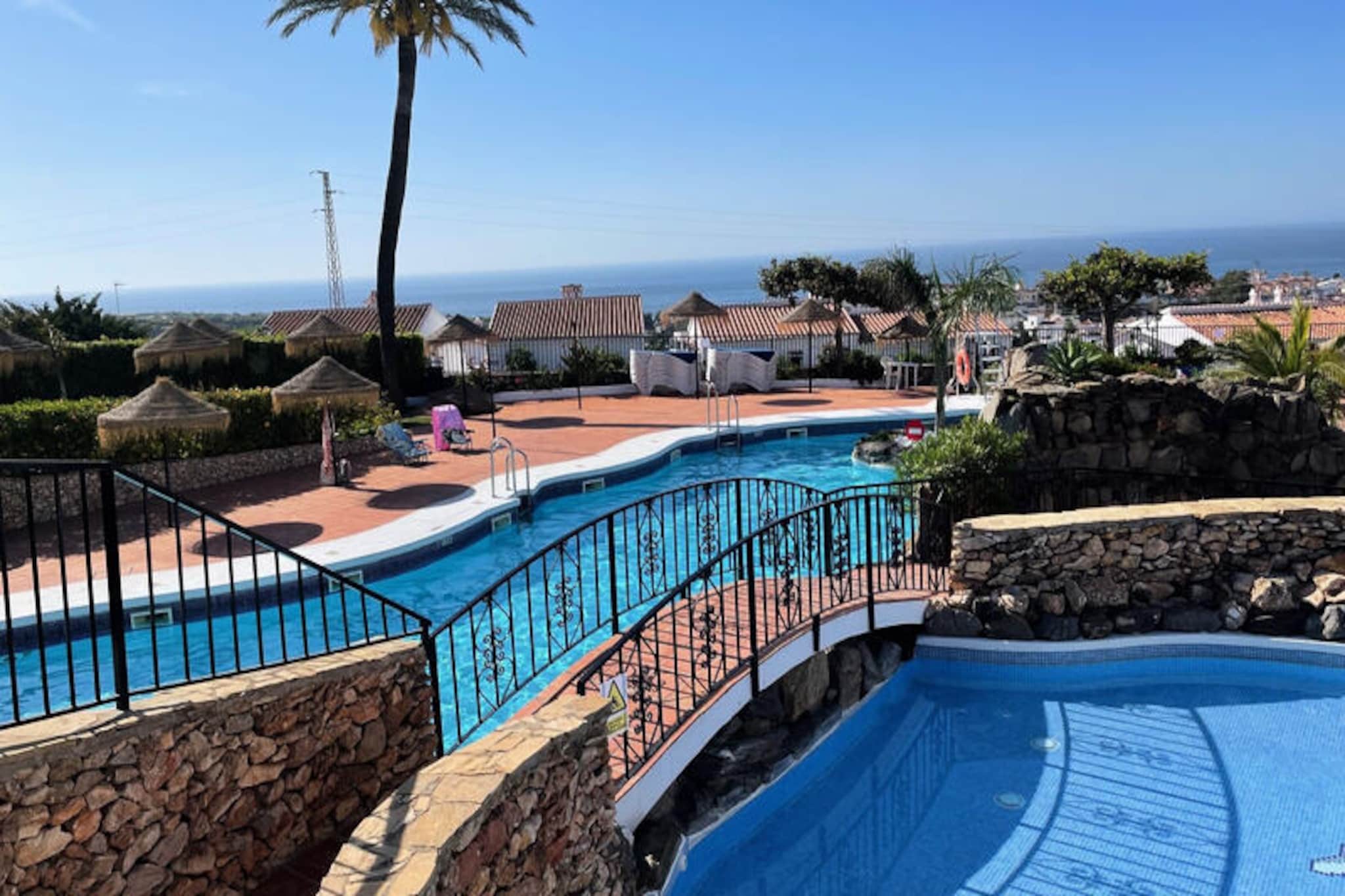 In the sun-drenched hills of Nerja, this beautifully renovated two-story townhouse in Capistrano Village offers a serene escape with all the comforts of home. Surrounded by lush Mediterranean gardens and the charm of Andalusian architecture, this property invites you to unwind and soak in the tranquil atmosphere of southern Spain. Whether you're lounging on the spacious terrace with a morning coffee or enjoying the vibrant local life, every moment here feels like a retreat.
Inside, the townhouse is thoughtfully designed for comfort and convenience. The ground floor features a bright, open-plan living room with a fully equipped kitchen, perfect for preparing meals with fresh local ingredients. A guest toilet is also located on this level. Upstairs, you'll find two cozy bedrooms—one with a double bed and the other with two singles—each with its own private balcony. The modern bathroom includes a shower and a washing machine, while air conditioning and heating in every room ensure a comfortable stay year-round. Free Wi-Fi and a TV with an extensive selection of international channels add to the home's modern amenities.
The Capistrano Village complex boasts several swimming pools, including one open year-round, as well as a small supermarket and a restaurant for your convenience. Located just 2 km from the golden sands of Burriana Beach and the charming center of Nerja, the townhouse is ideally situated for exploring the area. A local bus service and on-site parking make getting around effortless.
Whether you're seeking a peaceful getaway or an adventure-filled holiday, this townhouse offers the perfect base to experience the beauty and culture of the Costa del Sol. Let the warm Andalusian sun and the gentle sea breeze create unforgettable memories for you and your loved ones.