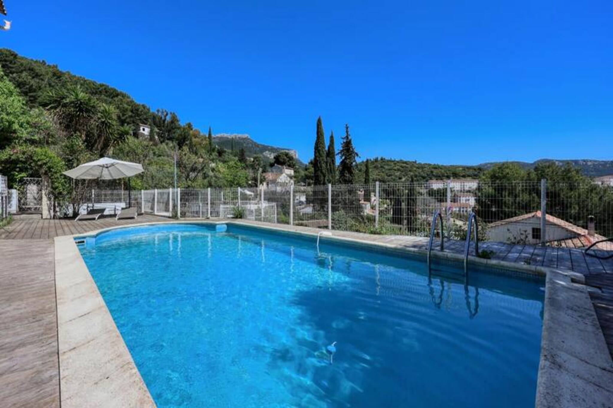 Imagine waking up to the serene beauty of Mont Faron, with its majestic silhouette greeting you each morning from your private terrace. This stunning 105 m² villa in Toulon offers the perfect blend of modern comfort and Provençal charm, creating an idyllic retreat for families or groups of up to 8 people. Nestled in a peaceful cul-de-sac, this property invites you to unwind and savor the relaxed Mediterranean lifestyle. 
 
 Step inside to discover a bright and spacious living area, complete with a cozy sofa bed, a dining space, and a fully equipped open-plan kitchen featuring all the essentials, from a coffee machine to a dishwasher. The villa boasts three elegant bedrooms: two with plush double beds and one with two single beds, ensuring restful nights for everyone. Two sleek bathrooms with showers and modern amenities like air conditioning, Wi-Fi, and a TV add to the convenience. Outside, the furnished terrace and private swimming pool provide the perfect setting for al fresco dining and sun-soaked afternoons.
 
 Toulon’s vibrant charm awaits just minutes away. Explore the bustling Cours Lafayette market, the historic Port of Toulon, and the golden beaches along the coast. Nearby bakeries, pizzerias, and shops cater to your daily needs, while gourmet restaurants like Le Pastel promise unforgettable culinary experiences. For nature lovers, the coastal path and Mont Faron’s trails offer breathtaking vistas and outdoor adventures.
 
 Whether you’re seeking relaxation, exploration, or a taste of Provençal culture, this villa is your gateway to an unforgettable holiday. Let the gentle rhythm of Toulon’s sun-drenched days and starry nights create memories to cherish forever.