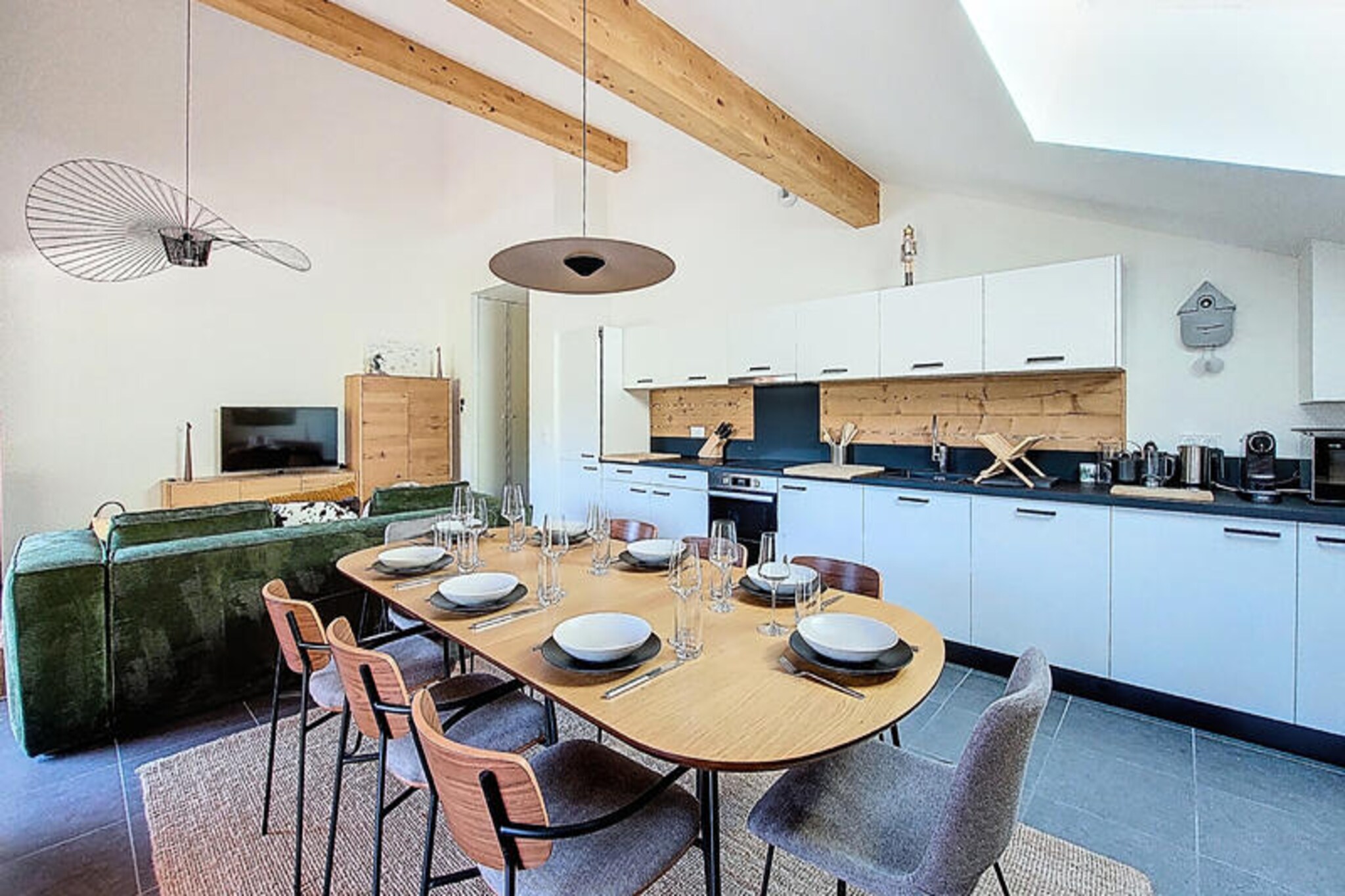 At the edge of the picturesque Saint-Jean-d'Aulps resort, this brand-new apartment offers a seamless blend of modern comfort and alpine charm. With ski-in/ski-out access directly to the slopes, it’s a haven for winter sports enthusiasts and a tranquil retreat for summer adventurers. Imagine waking up to breathtaking mountain views from your private terrace, sipping coffee as the fresh alpine air invigorates your senses. Whether you’re here for skiing, hiking, or simply relaxing, this property invites you to experience the beauty of the French Alps in style. \n\nStep inside and discover a thoughtfully designed space furnished with high-quality materials. The main room features a fully equipped kitchen with everything from an induction hob to a coffee maker, perfect for preparing hearty meals after a day on the slopes. The dining area comfortably seats eight, while the living room boasts a velvet sofa, armchairs, a wood-burning stove, and board games for cozy evenings. Four bedrooms, including two en suite, provide flexible sleeping arrangements for families or groups. Modern amenities like Wi-Fi, a washing machine, dryer, and an elliptical trainer ensure your stay is as convenient as it is comfortable. \n\nLocated in the heart of the resort, you’ll find easy access to local shops, restaurants, and ski facilities. In summer, the area transforms into a paradise for hikers and cyclists, with trails leading to stunning vistas and peaceful alpine meadows. For added convenience, the property includes a private ski locker with a boot dryer, a garage with an electric car charging point, and optional breakfast and airport transfer services. \n\nWhether you’re seeking thrilling outdoor adventures or serene mountain escapes, this apartment is the perfect base for creating unforgettable memories in Saint-Jean-d'Aulps.
