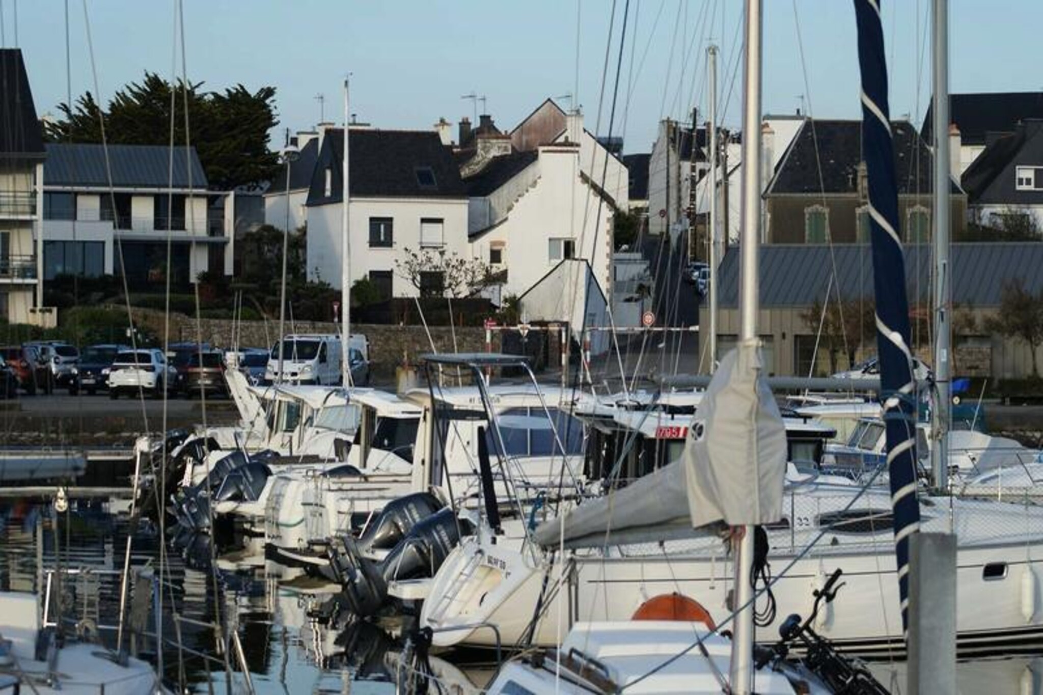 Overlooking the picturesque port of Etel, this charming coastal retreat offers a perfect blend of comfort and convenience for your next getaway. Imagine waking up to serene views of the water, strolling to nearby shops and beaches, and enjoying the vibrant atmosphere of this idyllic seaside town. Whether you're seeking relaxation or adventure, this house is an ideal base for exploring the treasures of southern Brittany, including Kerhillio beach, Saint-Cado Island, Carnac, Auray, and the stunning Gulf of Morbihan—all within easy reach by car. \n\nSpanning 115 m², the house is thoughtfully designed to accommodate up to eight guests. The ground floor features a cozy living room with a sofa bed and armchairs, a separate fully equipped kitchen with modern appliances, and a dining area that opens onto a private courtyard. Upstairs, you'll find three inviting bedrooms, including a master bedroom with a double bed and views of the port, a room with two single beds, and a third bedroom with a pull-out bed and two single beds. The attic level provides additional space with a sofa bed and a games area, perfect for unwinding after a day of exploration. \n\nThe location is unbeatable, with beaches, shops, and restaurants just steps away. Take a leisurely walk along the port, savor fresh seafood at local eateries, or venture further to discover the region's rich history and natural beauty. From the megalithic sites of Carnac to the charming streets of Vannes, every corner of Brittany offers something unique. \n\nWhether you're traveling with family or friends, this house provides the perfect setting for creating lasting memories. With its welcoming ambiance, stunning views, and proximity to key attractions, your Breton escape awaits.