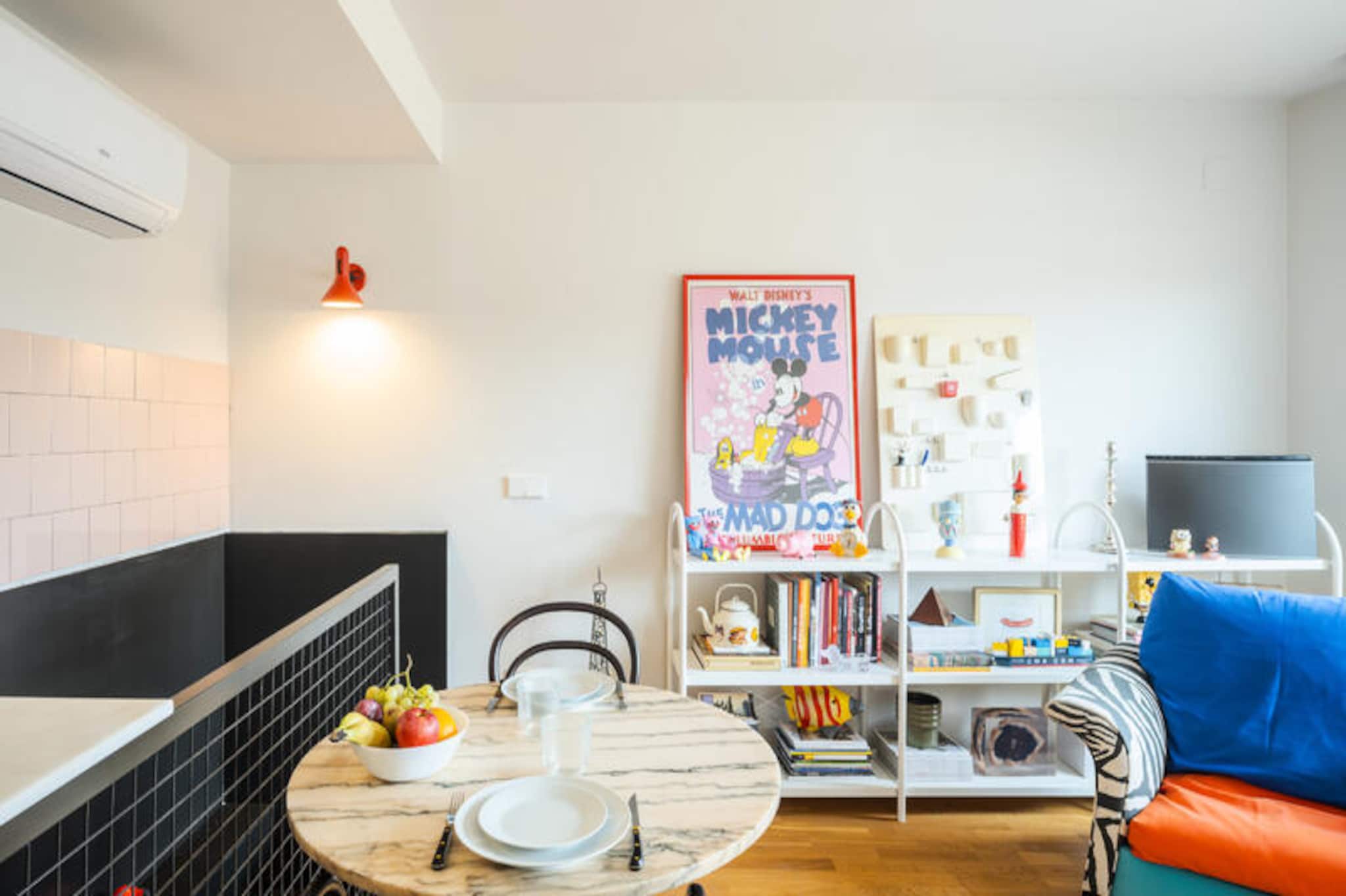 Step into a world of vibrant charm and retro elegance at Majordoms Retrocentric, a unique two-level mini-loft nestled in the heart of Banyoles. This accommodation is a celebration of mid-century design, playful eccentricity, and bold colors, offering a warm and inviting atmosphere for solo travelers or couples seeking a one-of-a-kind retreat. From the moment you enter, you’ll be captivated by the thoughtful details and creative touches that make this space truly special. \n\nOn the ground floor, you’ll find an open-plan bedroom with an en-suite bathroom featuring a modern shower and integrated toilet, ensuring both style and functionality. The first floor boasts a bright living and dining area seamlessly connected to a fully equipped kitchen, perfect for preparing meals with ease. Step out onto your private terrace, a tranquil haven ideal for morning coffee or evening drinks under the stars. Every corner of this loft has been meticulously designed to maximize comfort and aesthetic appeal, blending modern convenience with a welcoming ambiance. \n\nLocated just steps from Plaça Major, Majordoms Retrocentric places you in the heart of Banyoles’ historic charm. Stroll through cobbled streets lined with boutiques and cafes, or take a leisurely 20-minute walk to Lake Banyoles, where you can unwind or enjoy activities like rowing and cycling. Nearby, the Neolithic Park of La Draga offers a fascinating glimpse into ancient history, while the sandy beaches of L’Escala and L’Estartit are perfect for a day trip. Girona, Figueres, and the Costa Brava are all within easy reach, making this loft an ideal base for exploring the region. \n\nWhether you’re here for a weekend getaway or a longer stay, Majordoms Retrocentric promises an unforgettable experience. With its stylish design, prime location, and thoughtful amenities, it’s more than just a place to stay—it’s a place to feel at home. Book your stay today and discover the magic of Banyoles in this exceptional retreat.