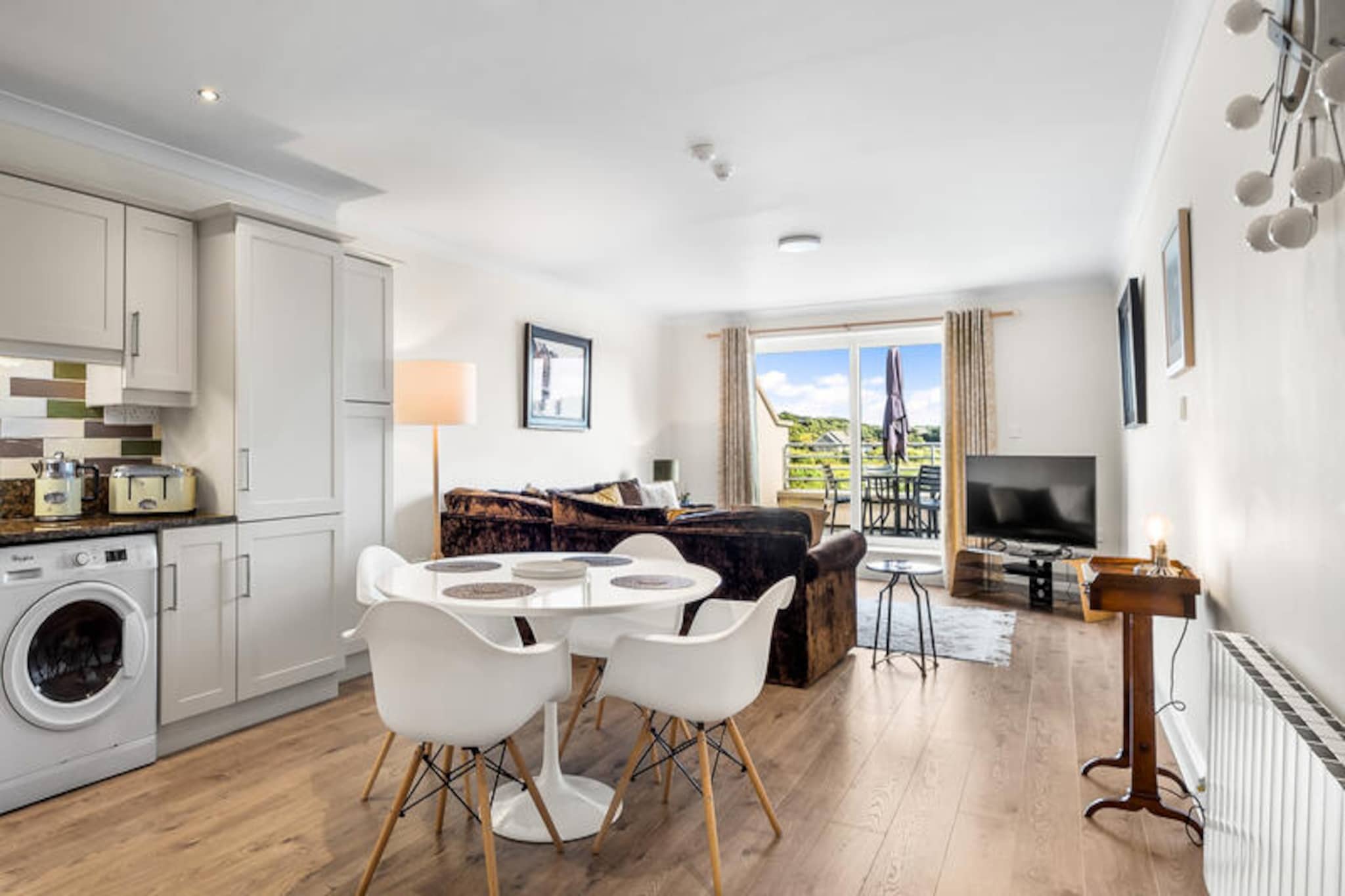 Overlooking the shimmering waters of Clifden Bay, this charming apartment invites you to experience the essence of coastal Ireland. With its serene ambiance and breathtaking views, it’s the perfect retreat for couples or small families seeking a tranquil getaway. Whether you’re sipping morning coffee on the balcony or exploring the vibrant town of Clifden just steps away, every moment here feels like a celebration of the Wild Atlantic Way’s beauty and charm.  
                      The apartment spans 100 m² and comfortably accommodates up to four guests in two cozy bedrooms. Designed with modern convenience in mind, the open-plan kitchen is fully equipped with electric appliances, including a dishwasher, microwave, and coffee maker, making meal preparation a breeze. Relax in the inviting living area with satellite TV and Wi-Fi, or enjoy the fresh sea air from the balcony. Additional amenities such as a washing machine, dryer, and on-site parking ensure a hassle-free stay.  
                      Located in the heart of Clifden, the property is surrounded by a wealth of attractions and facilities. From the renowned Mannions Seafood Bar and Connemara Seaweed Baths to the scenic Coral Strand Beach just 8 km away, there’s something for everyone. Explore the rugged beauty of Connemara National Park, tee off at nearby golf courses, or simply stroll through the town’s vibrant streets filled with cafes, shops, and traditional Irish pubs.  
                      Whether you’re drawn by the promise of adventure or the allure of relaxation, this apartment offers an unforgettable base to discover the magic of Ireland’s west coast. Let the rhythm of the waves and the charm of Clifden create memories that will last a lifetime.