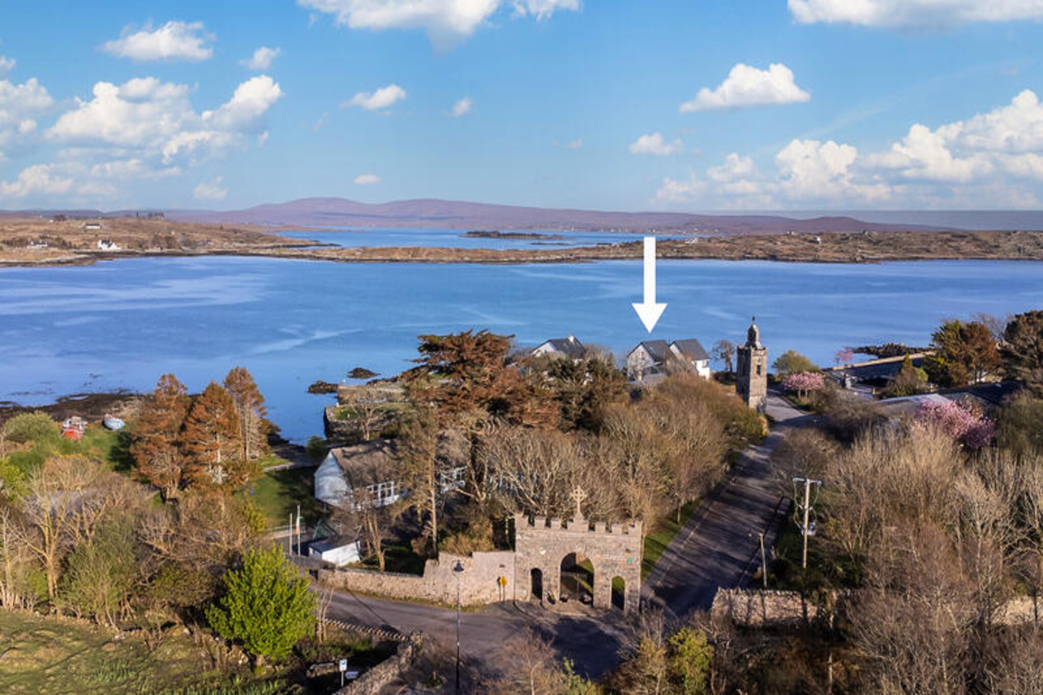 On the rugged coastline of Connemara, this charming house in Roundstone offers a serene escape with breathtaking sea and mountain views. Surrounded by the natural beauty of Ireland’s west, this property is a perfect retreat for those seeking tranquility and adventure in equal measure. Whether you’re watching the waves crash against the shore or exploring the quaint village of Roundstone, every moment here feels like a step into a postcard. \n\nThe house boasts three cozy bedrooms, comfortably accommodating up to five guests. Its spacious 102 m² layout is thoughtfully designed for relaxation, featuring a bright living area with a television and Wi-Fi for your convenience. The American-style kitchen is fully equipped with modern appliances, including a refrigerator, microwave, oven, and dishwasher, making it easy to prepare meals with fresh local ingredients. Additional amenities such as a washing machine, electric heating, and on-site parking ensure a comfortable and hassle-free stay. Step outside to enjoy the garden furniture and soak in the crisp Atlantic air. \n\nLocated just 550 meters from the heart of Roundstone village, you’ll find a delightful selection of restaurants, cafés, and shops nearby. For beach lovers, the stunning Gurteen Bay and Dog’s Bay are just a short drive away, offering pristine sandy shores and crystal-clear waters. Explore the vibrant town of Clifden, only 23 km away, or immerse yourself in the wild beauty of Connemara National Park, just 37 km from your doorstep. Golf enthusiasts will appreciate the proximity to Connemara Golf Links, while nature lovers can enjoy scenic walks along the nearby lakes and rivers. \n\nWhether you’re planning a family getaway or a peaceful retreat, this Roundstone home invites you to experience the magic of Ireland’s west coast. With its idyllic location and modern comforts, it’s the perfect base for creating unforgettable memories.