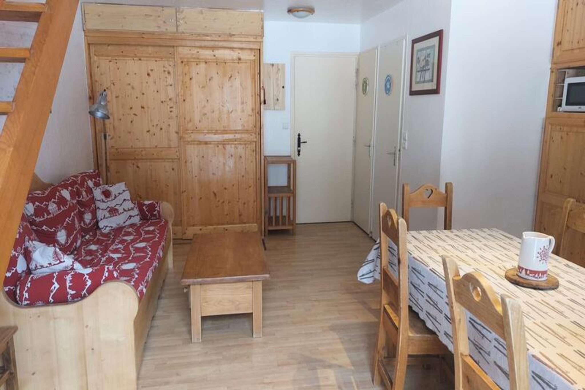 In the heart of the charming village of Valloire, this cozy duplex apartment offers a delightful alpine escape for both winter and summer adventures. Just steps away from local shops and nestled within the Clos des Etoiles residence, its central location ensures easy access to everything you need for a memorable stay. Whether you're here to carve through pristine ski slopes or bask in the summer sunshine, this property places you at the center of it all. Wake up to the crisp mountain air and enjoy serene mornings on your east-facing balcony, soaking in the tranquil views of the surrounding peaks. \n\nDesigned with comfort and practicality in mind, the apartment accommodates up to eight guests across two levels. Upstairs, you'll find two inviting bedrooms with skylights, a mezzanine with bunk beds, and downstairs, a spacious living area featuring a pull-out sofa bed. The well-equipped kitchenette includes modern appliances such as an oven, microwave, ceramic stovetop, refrigerator, dishwasher, and washing machine—perfect for preparing hearty meals after an active day. Two bathrooms, one on each level, provide convenience for larger groups, while amenities like a television, wardrobe, and ski locker ensure a hassle-free stay. \n\nWinter guests will appreciate the proximity to the Crêt de la Brive gondola lift, just 280 meters away, and the ski school meeting point, making it ideal for families and beginners. In summer, the leisure center with a swimming pool, ice rink, and wellness area is only 220 meters away, while the children's playground is a short 400-meter stroll. The vibrant village atmosphere offers a mix of outdoor activities, local dining, and cultural experiences to suit every traveler. \n\nWhether you're seeking thrilling ski runs, scenic hiking trails, or simply a peaceful retreat in the French Alps, this duplex apartment is your gateway to unforgettable moments. Let the beauty of Valloire inspire your next adventure.