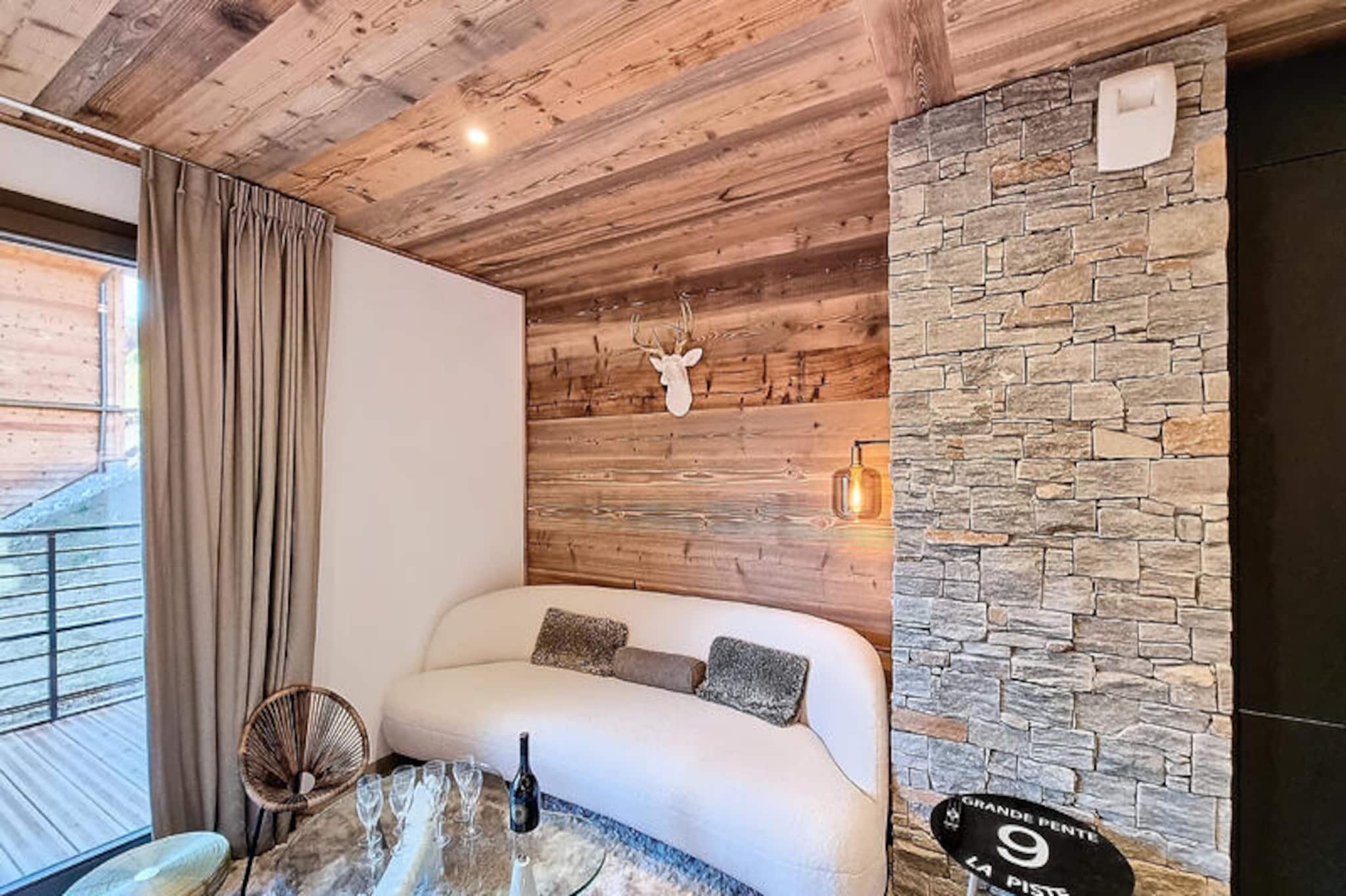 In the heart of the charming Les Gets ski resort, this beautifully designed 100 m² apartment offers a warm and inviting retreat for your mountain holiday. Surrounded by the breathtaking landscapes of the French Alps, this property combines modern comfort with alpine charm, creating the perfect setting for unforgettable family moments. Whether you're here to carve through pristine slopes or simply relax in a serene environment, this home is your gateway to a magical winter or summer escape. \n\nThe apartment comfortably accommodates up to 8 guests across 4 thoughtfully arranged bedrooms. Two double bedrooms feature en-suite bathrooms for added privacy, while a third double bedroom and a cozy cabin room with bunk beds share a spacious shower room. Each double bedroom is equipped with its own television, and all bathrooms are fitted with hairdryers for your convenience. The open-plan kitchen is fully equipped, boasting a refrigerator, dishwasher, microwave, raclette grill, and fondue set—perfect for preparing hearty alpine meals. Additional amenities include a washing machine, two ski storage spaces, and a cellar, ensuring a hassle-free stay. The property also offers a two-space underground garage and complimentary Wi-Fi.\n\nIdeally located just 50 meters from the market square and less than 200 meters from the supermarket and local shops, this apartment places you at the heart of Les Gets' vibrant village life. The ski lifts are an easy 8-minute walk away, while a nearby shuttle stop provides convenient access to Alta Lumina, a magical light and sound experience. Whether you're exploring the slopes, strolling through the village, or enjoying the region's culinary delights, everything you need is within reach.\n\nChoose this delightful apartment for your next alpine getaway and create cherished memories in the enchanting surroundings of Les Gets. With its blend of comfort, style, and unbeatable location, it's the perfect home base for your mountain adventures.