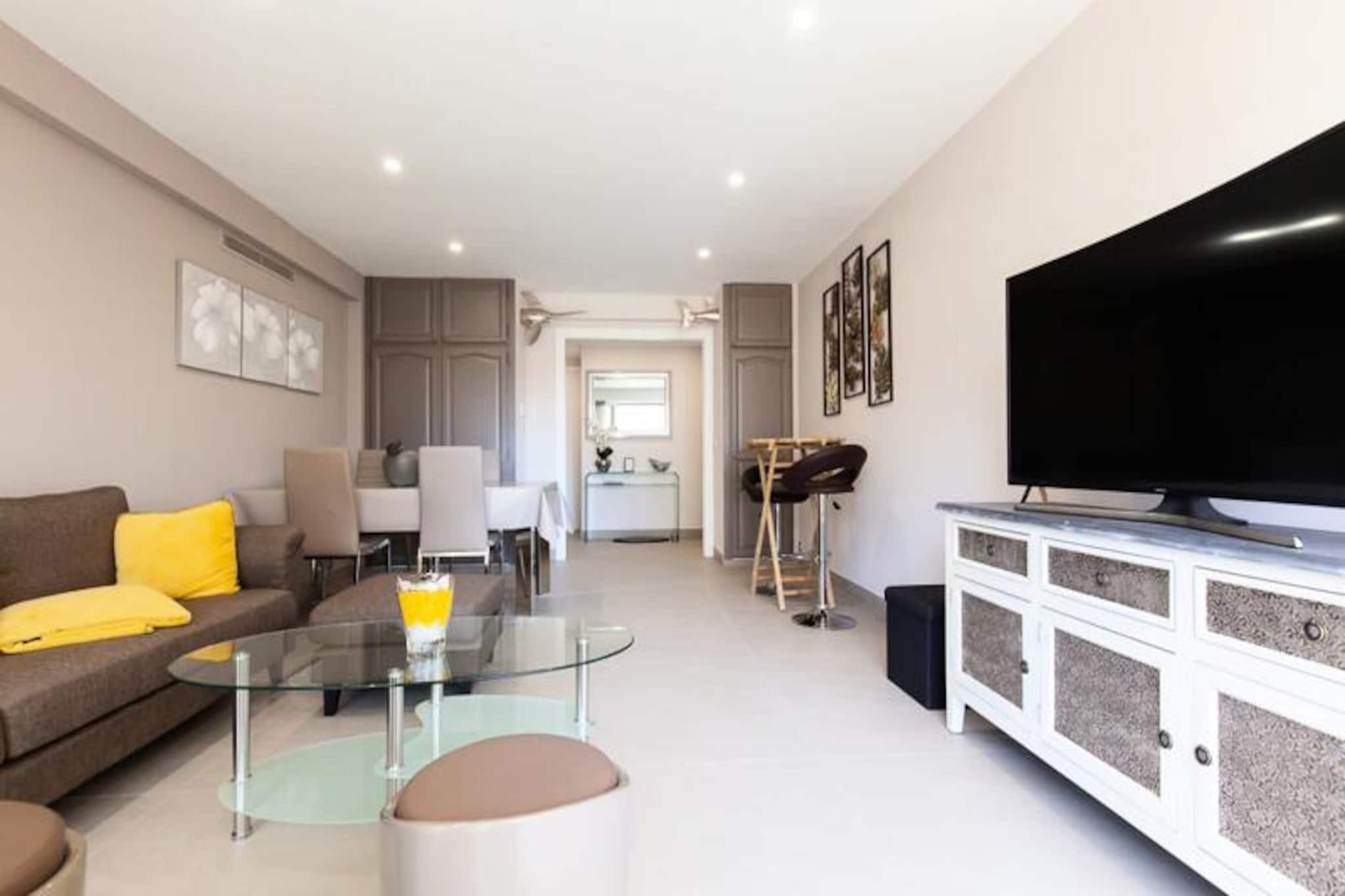 Step into a world of refined elegance and coastal charm with this stylish 82m² apartment in the heart of Cannes. Perfectly situated near Mouré Beach and the iconic Croisette, this property offers a seamless blend of comfort and convenience, making it an ideal retreat for travelers seeking both relaxation and exploration. Imagine sipping your morning coffee on the private terrace as the Mediterranean breeze gently greets you, or strolling to nearby shops and restaurants to immerse yourself in the vibrant local culture. With its prime location, every day presents a new adventure along the French Riviera. \n\nDesigned with care and attention to detail, the apartment exudes a warm, inviting atmosphere that feels like a true home away from home. The living room, adorned with a cozy sofa and flat-screen TV, opens onto a sunlit terrace perfect for alfresco breakfasts or evening aperitifs. The fully equipped kitchen provides everything you need to prepare delicious meals, while the two spacious bedrooms, each featuring a king-size bed, ensure restful nights. The master bedroom boasts an ensuite shower room and desk overlooking a tranquil garden, while the second bathroom offers a luxurious bathtub and walk-in shower for ultimate relaxation. \n\nBeyond the apartment, the allure of Cannes awaits. A short walk leads you to Mouré Beach, the Croisette, and the serene Jardin des Hespérides, while a quick drive connects you to the Palais des Congrès and the bustling Rue d’Antibes. Whether you’re exploring the Riviera by train or enjoying a game of pétanque at Place de l’Étang, this location places you at the heart of it all. \n\nWith premium amenities like air conditioning, double glazing, and a secure underground garage, this apartment is more than a place to stay—it’s a gateway to unforgettable memories in one of France’s most glamorous destinations.