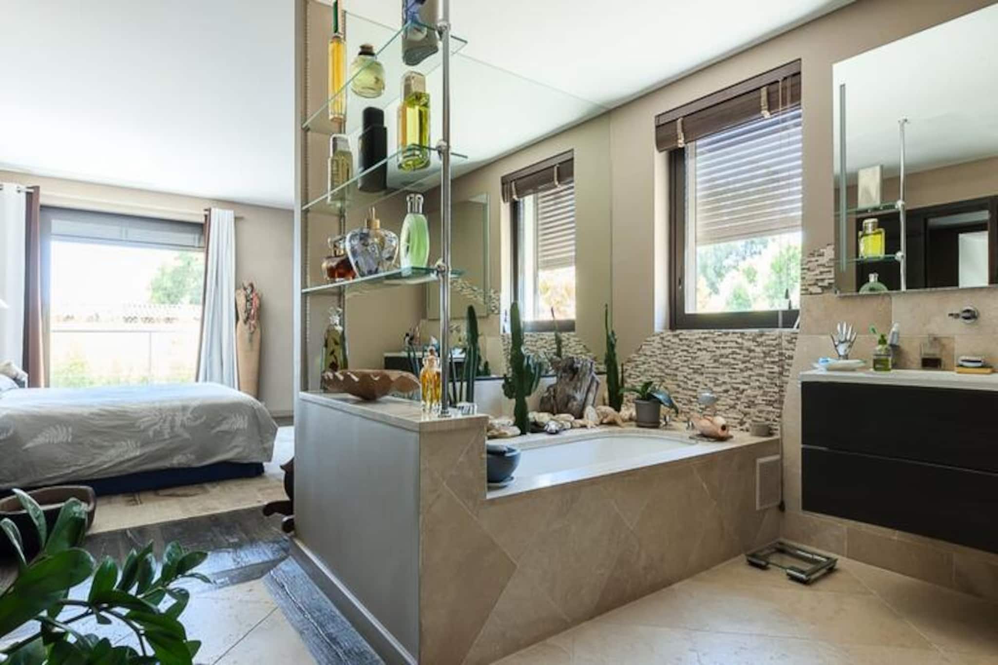 In the heart of the French Riviera, this exquisite villa offers a perfect blend of luxury and comfort, promising unforgettable moments for families and groups alike. Imagine waking up to the Mediterranean breeze, just a 10-minute stroll from the pristine beaches of Juan-les-Pins, renowned for their vibrant atmosphere, gourmet restaurants, and lively casino. Whether you’re seeking relaxation or adventure, this villa is your gateway to the best of the Côte d'Azur. \n\nStep inside this tastefully decorated 220m² home, spread across three levels, where every detail has been thoughtfully designed to enhance your stay. The ground floor welcomes you with a spacious living area featuring plush sofas, a large-screen TV, and a dining space for eight. The semi-open kitchen, equipped with modern appliances, invites culinary creativity, while the en suite bedroom with garden access offers a private retreat. Upstairs, the master suite boasts a dressing room, open-plan bathroom, and terrace access, alongside two additional bedrooms, one perfect for children. The rooftop solarium on the second floor, with its stunning sea view, is ideal for evening aperitifs. \n\nOutside, the villa’s amenities are equally impressive. Dive into the heated lap pool, unwind in the six-person jacuzzi, or enjoy a friendly game of foosball under the shaded shelter. The manicured garden and artificial grass provide a safe and serene space for children to play, while the terrace sets the stage for memorable al fresco dining experiences. \n\nPerfectly situated, you’re just minutes from Antibes’ charming old town, Cannes’ iconic Croisette, and Biot’s family-friendly attractions like Marineland. Whether exploring the Riviera’s glamorous cities or relaxing in your private oasis, this villa ensures a holiday filled with luxury, comfort, and unforgettable memories.