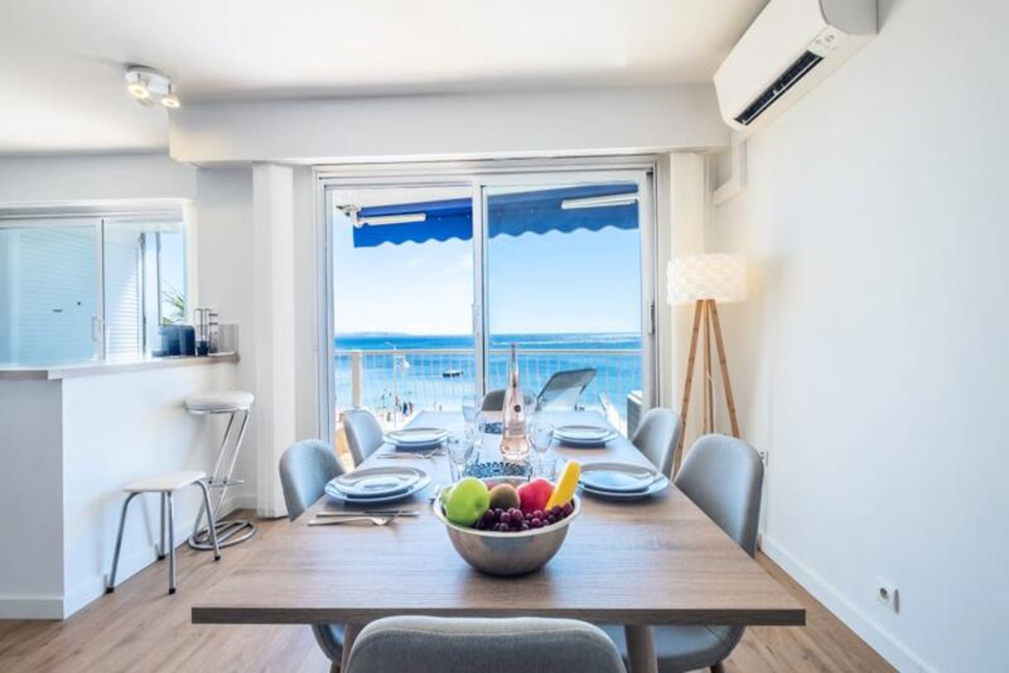 Awaken to the soothing sound of waves and the breathtaking panorama of the Lérins Islands from this beautifully renovated beachfront apartment in the heart of Cannes. Just steps from the serene Palm Beach, this property offers an unparalleled seaside escape where the Mediterranean becomes your backyard. Whether you’re enjoying a morning coffee on the terrace or an evening stroll along the golden sands of Mouré Rouge, every moment here is infused with the charm of coastal living.
Inside, the apartment is designed for comfort and style. The spacious living room opens directly onto the terrace, offering uninterrupted sea views. A plush sofa, smart TV, and dining area for six create a welcoming space to relax and unwind. The open-plan kitchen is fully equipped, perfect for preparing meals with fresh local ingredients. The master bedroom, with its queen-size bed and wall-mounted TV, ensures restful nights, while the second bedroom with bunk beds is ideal for children or additional guests. A modern shower room with WC completes the interior, blending functionality with elegance.
Step outside and you’ll find yourself in a vibrant neighborhood. A charming village-style shopping street, just a four-minute walk away, offers everything from a bakery to a fishmonger. Indulge in fine dining at nearby restaurants or relax on private beaches. For a taste of glamour, the iconic Croisette and Palais des Festivals are within easy reach, as are the luxury boutiques of Rue d’Antibes.
With free parking, Wi-Fi, and a concierge service at your disposal, this apartment is the perfect base for exploring Cannes and the French Riviera. Whether you’re here to unwind, explore, or indulge, this beachfront retreat promises an unforgettable stay.