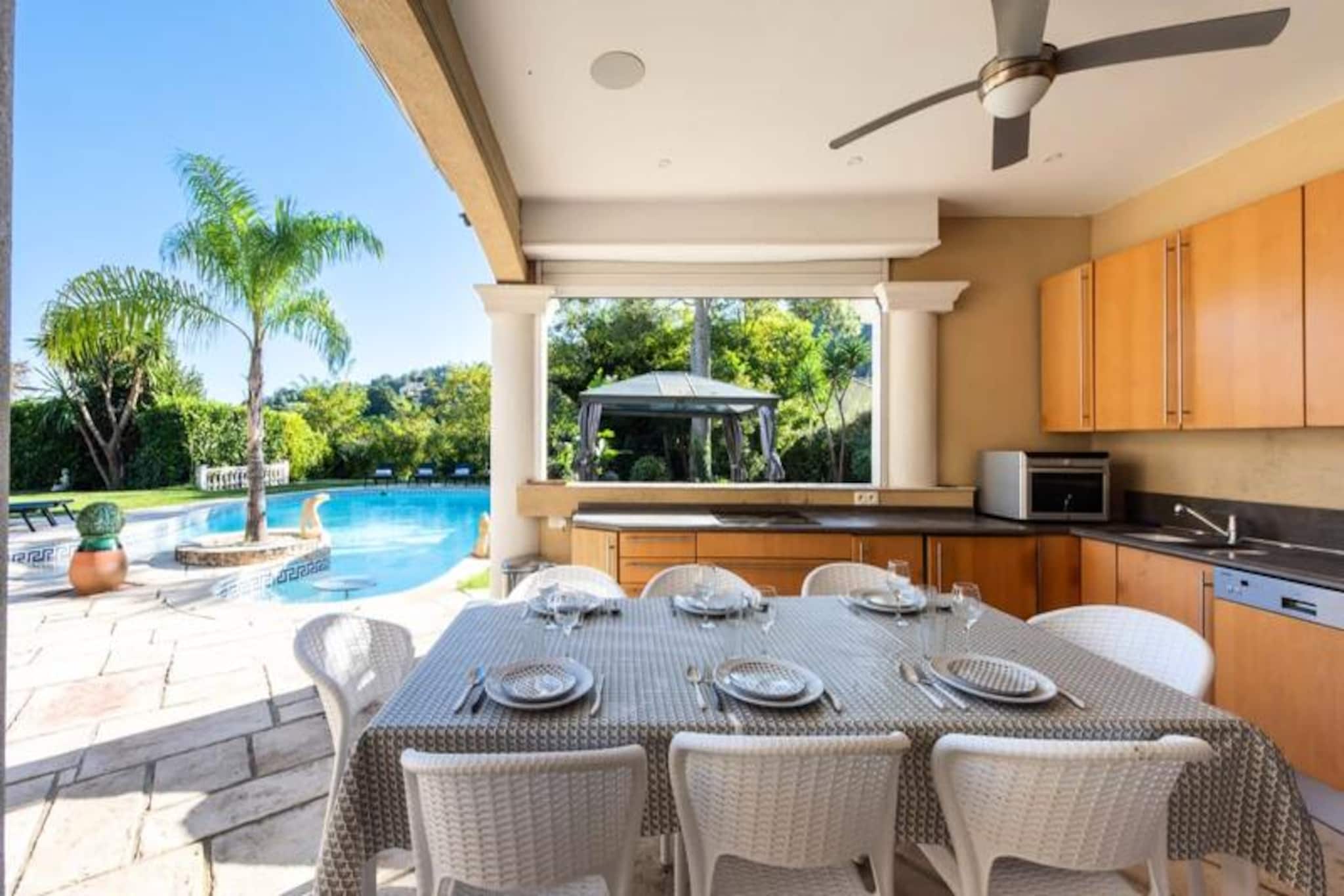 High above the sparkling coastline of Super Cannes, this luxurious villa offers an unparalleled retreat where tranquility and elegance converge. Imagine waking to the gentle hum of cicadas and the scent of Mediterranean blooms, with panoramic views stretching across the verdant hills and azure sea. This is your private haven, a place to unwind and reconnect with loved ones amidst the beauty of the French Riviera. \n\nStep inside this meticulously designed 330m² villa, where every detail has been crafted to ensure comfort and sophistication. With six spacious bedrooms and five bathrooms, the property accommodates large families or groups of friends with ease. The open-plan living spaces feature high ceilings, modern furnishings, and abundant natural light, while the fully equipped kitchens invite you to create culinary delights. Outdoors, the heated pool and jacuzzi promise relaxation under the sun, while the summer kitchen and expansive terraces set the stage for memorable al fresco dining experiences. \n\nLocated just minutes from the beaches of Cannes and Golfe Juan, this villa is perfectly positioned to explore the region’s treasures. Stroll along the iconic Croisette, indulge in fine dining by the sea, or venture to nearby villages like Biot and Valbonne for a taste of Provençal charm. For those seeking adventure, the vibrant nightlife of Juan-les-Pins and the perfume factories of Grasse are within easy reach. \n\nWhether you’re basking in the Riviera sunshine or enjoying the villa’s cinema and arcade room, this property offers a seamless blend of luxury and leisure. Make unforgettable memories in a setting that feels like a slice of paradise.