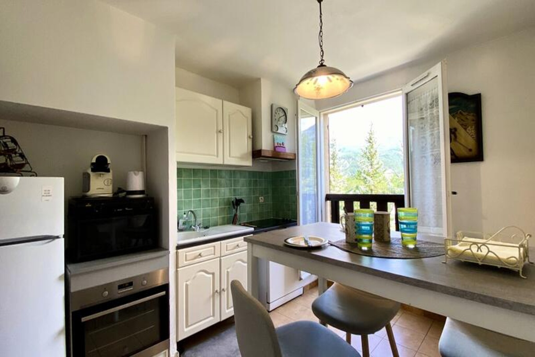 In the heart of the serene Ubaye Valley, this charming two-bedroom apartment offers a perfect blend of rustic mountain charm and modern convenience. With its west and east-facing orientation, the space is bathed in natural light throughout the day, creating a warm and inviting atmosphere. Located on the second floor of a peaceful residence near the Bois Chenu Golf Course, it’s an ideal retreat for those seeking tranquility and easy access to the vibrant town of Barcelonnette, just a short shuttle ride away.
The apartment spans 68m² and comfortably accommodates 4 to 5 guests. The living room, featuring a cozy sofa, armchair, and flat-screen TV, invites you to unwind after a day of exploration. The separate kitchen is a culinary enthusiast’s dream, equipped with modern appliances including a dishwasher, oven, microwave, and even specialty items like a raclette grill and crepe maker. Two thoughtfully designed bedrooms provide restful retreats: one with a double bed and the other with flexible bedding options to suit your needs. A bathroom with a bathtub and washing machine adds to the convenience, while a separate WC ensures privacy.
Step outside to enjoy the stunning alpine surroundings. Whether you’re teeing off at the nearby golf course, exploring the charming streets of Barcelonnette, or embarking on mountain adventures, this location offers something for everyone. The residence also provides dedicated parking, making it easy to explore the wider region.
This non-smoking, pet-free apartment is perfect for families or small groups looking for a cozy yet well-equipped base in the French Alps. With its prime location and thoughtful amenities, it promises an unforgettable stay amidst breathtaking natural beauty.