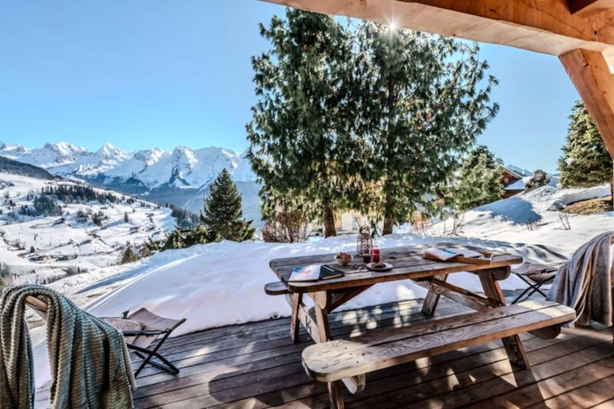 High above the picturesque valley of Le Grand Bornand, this stunning chalet invites you to experience the true essence of alpine living. With its breathtaking panoramic views of the Aravis mountain range, this spacious retreat blends traditional Savoyard charm with modern comfort, offering an idyllic escape for families and groups of up to 11 guests. Whether you’re seeking adventure or tranquility, this chalet is your gateway to unforgettable mountain memories.
Step inside and be greeted by a warm and welcoming living space, complete with a cozy fireplace and large windows that flood the room with natural light. The open-plan design seamlessly connects the fully equipped kitchen, dining area, and living room, creating the perfect setting for shared meals and relaxed evenings. With five beautifully appointed bedrooms, including a family suite with a mezzanine, and two modern bathrooms, every detail has been designed to ensure your comfort. The chalet also features a terrace with a griddle for summer barbecues and a double garage with ski storage and a boot dryer for winter adventures.
Located just a 9-minute drive from the ski lifts of Le Chinaillon, the chalet offers easy access to 220 km of slopes in the Aravis ski area, as well as Nordic skiing, snowshoeing, and dog sledding. In summer, hiking and cycling trails start right from your doorstep, leading you through lush alpine meadows and past local farms where you can sample fresh Reblochon cheese. Nearby, the shimmering waters of Lake Annecy beckon for paddleboarding and picnics, while the medieval streets of Annecy’s Old Town invite you to explore its vibrant markets and charming boutiques.
Whether you’re savoring chef-prepared dishes delivered to your door, relaxing with a massage in the chalet, or exploring the region’s countless outdoor activities, this chalet offers a perfect blend of luxury and authenticity. Make it your home base for an unforgettable alpine adventure.