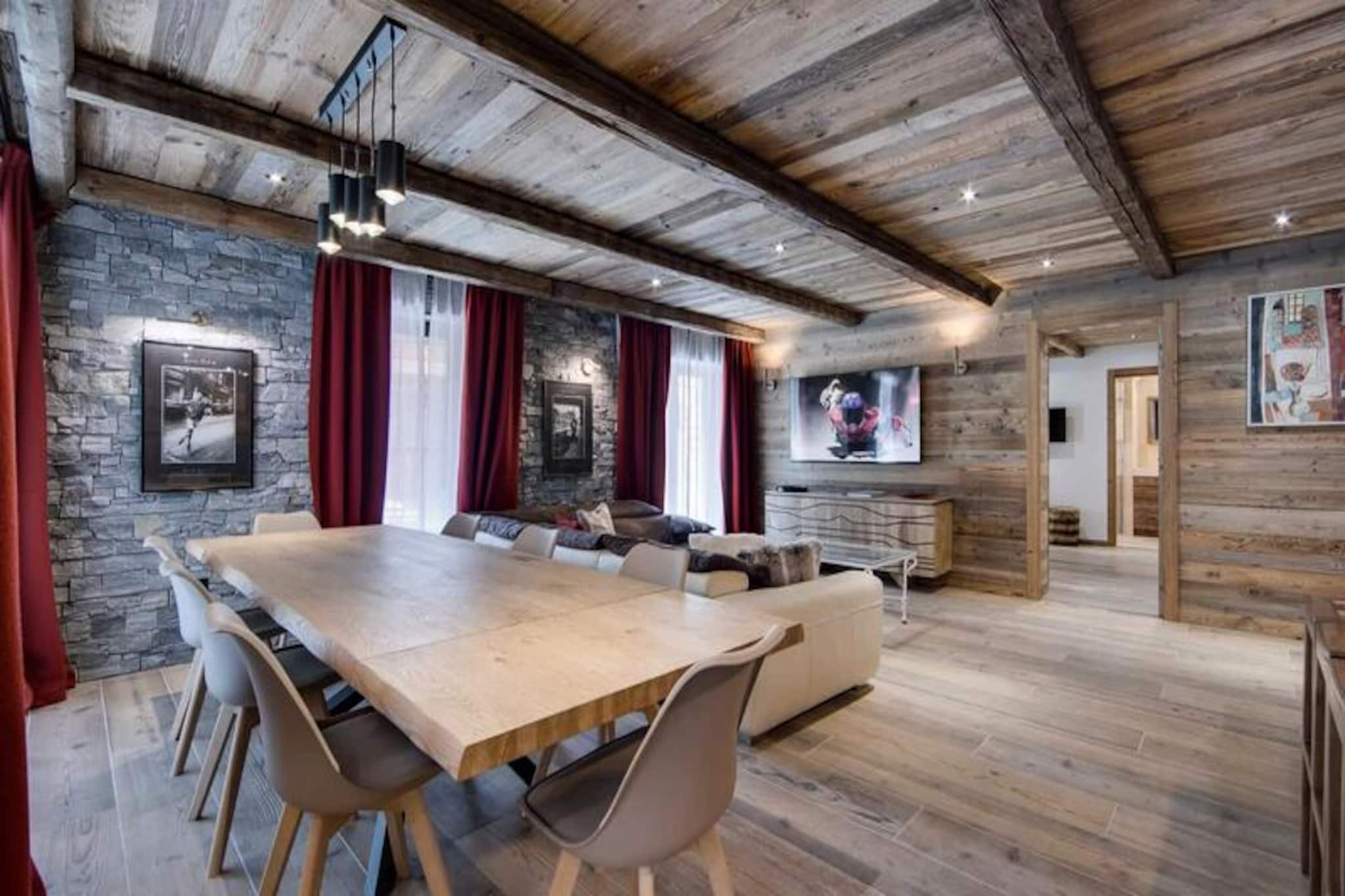 Amidst the serene beauty of the French Alps, this newly built residence in 2024 offers an unparalleled retreat for mountain enthusiasts. Situated between the Isère River and the majestic Solaise mountain range, the Turios 2 residence combines tranquility with convenience, providing ski-in/ski-out access and a mere five-minute walk to the resort center. Whether you're here to embrace the winter slopes or bask in the summer panoramas, this alpine haven promises an unforgettable stay. The nearby shuttle at 'Rond Point des Pistes' ensures effortless access to the vibrant town center, making exploration a breeze. \n\nDesigned with meticulous attention to detail, the apartment exudes the charm of a high-mountain chalet. Its wood-paneled interiors and warm ambiance create a welcoming atmosphere, perfect for unwinding after a day of adventure. Accommodating up to eight guests, the property boasts four spacious bedrooms, each with luxurious en-suite or adjacent bathrooms, ensuring privacy and comfort for all. The open-plan kitchen is fully equipped with modern appliances, including an induction hob, oven, microwave, and wine cellar, seamlessly connecting to the living and dining areas. A large terrace offers breathtaking views of the legendary Bellevarde slope, providing the perfect backdrop for your alpine escape. \n\nBeyond the apartment's exceptional amenities, the residence features covered parking for two cars, a ski locker with boot dryers, and thoughtful inclusions such as daily cleaning, fresh linens, and Wi-Fi. The surrounding area invites exploration, with pristine slopes, scenic trails, and the vibrant Val d'Isère village offering a mix of local cuisine, shopping, and cultural experiences. \n\nWhether you're seeking thrilling ski adventures or tranquil summer hikes, this residence is your gateway to the best of the Alps. Let the charm of Turios 2 captivate you and create lasting memories in this idyllic alpine retreat.