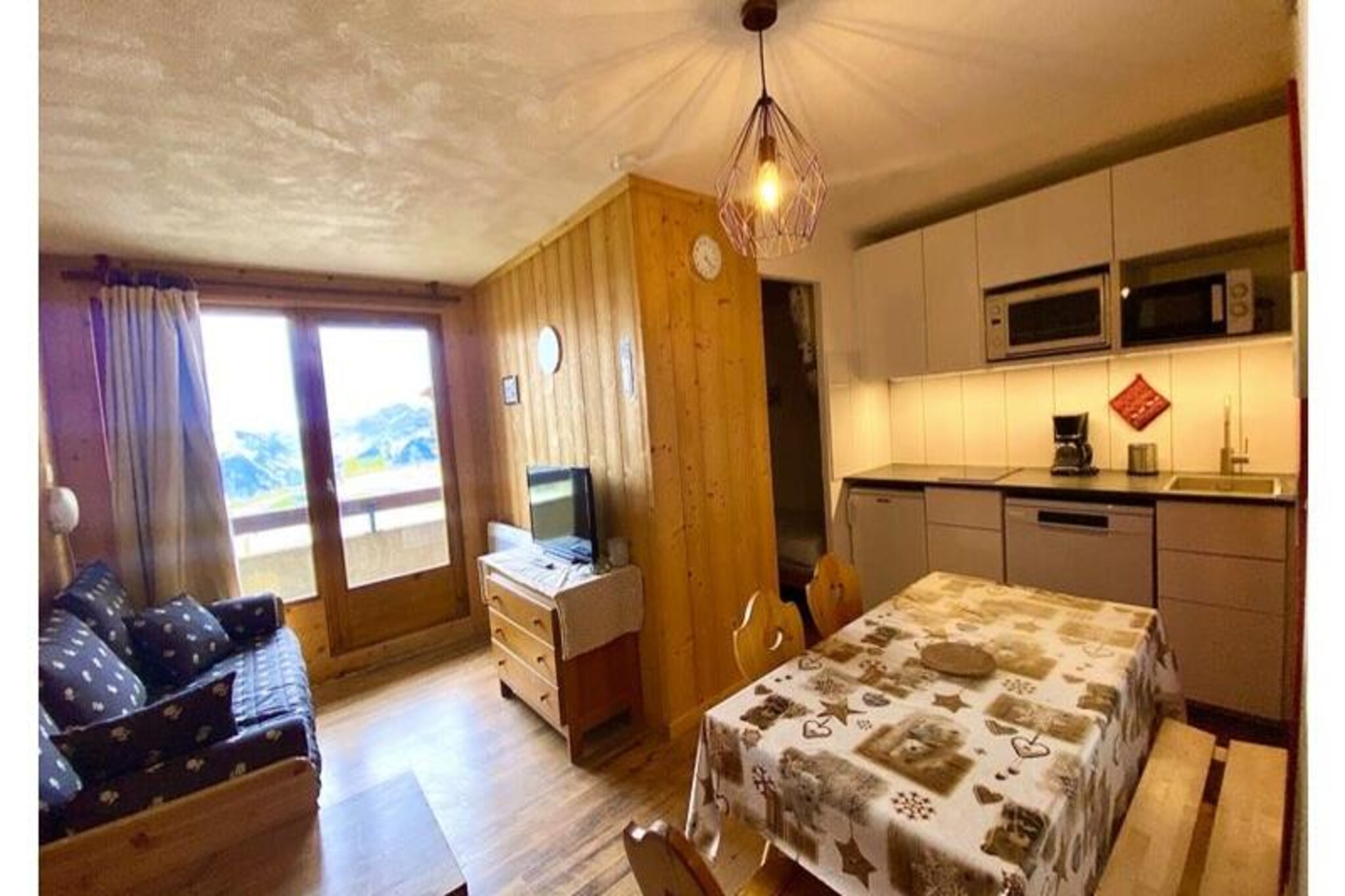 Basking in the golden light of the French Alps, this charming 2-room apartment in the heart of Plagne Soleil offers a cozy retreat for up to five guests. With breathtaking views of Aime 2000 and the valley, the residence is perfectly situated at the foot of the slopes, making it a dream destination for ski enthusiasts and nature lovers alike. Whether you're here to carve through pristine snow or explore scenic pedestrian paths, the vibrant alpine atmosphere will captivate you. 
 
 The thoughtfully designed 25m² apartment is located on the second floor and is accessible by elevator. The living room features a pull-out bed that transforms into two comfortable single beds, complemented by a flat-screen TV for cozy evenings in. The open-plan kitchen is fully equipped with modern appliances, including a dishwasher, refrigerator, oven, and microwave, ensuring you have everything you need to prepare delicious meals. The separate bedroom offers a single bed and a bunk bed, perfect for families or small groups. A bathroom with a bathtub and a separate WC complete the space, offering both comfort and convenience. Additional amenities include Wi-Fi and a ski locker for your gear.
 
 Plagne Soleil lives up to its name with its sun-drenched location and easy access to the vast Paradiski ski area. A free shuttle connects you to nearby Plagne Village, expanding your options for dining, shopping, and entertainment. In winter, enjoy direct access to the slopes, while summer brings opportunities for hiking and mountain exploration. The area's pedestrian paths offer serene walks with stunning alpine views, making it a year-round haven.
 
 Whether you're seeking thrilling adventures or peaceful moments in nature, this apartment is your gateway to unforgettable alpine memories. Book your stay and immerse yourself in the beauty and charm of Plagne Soleil.