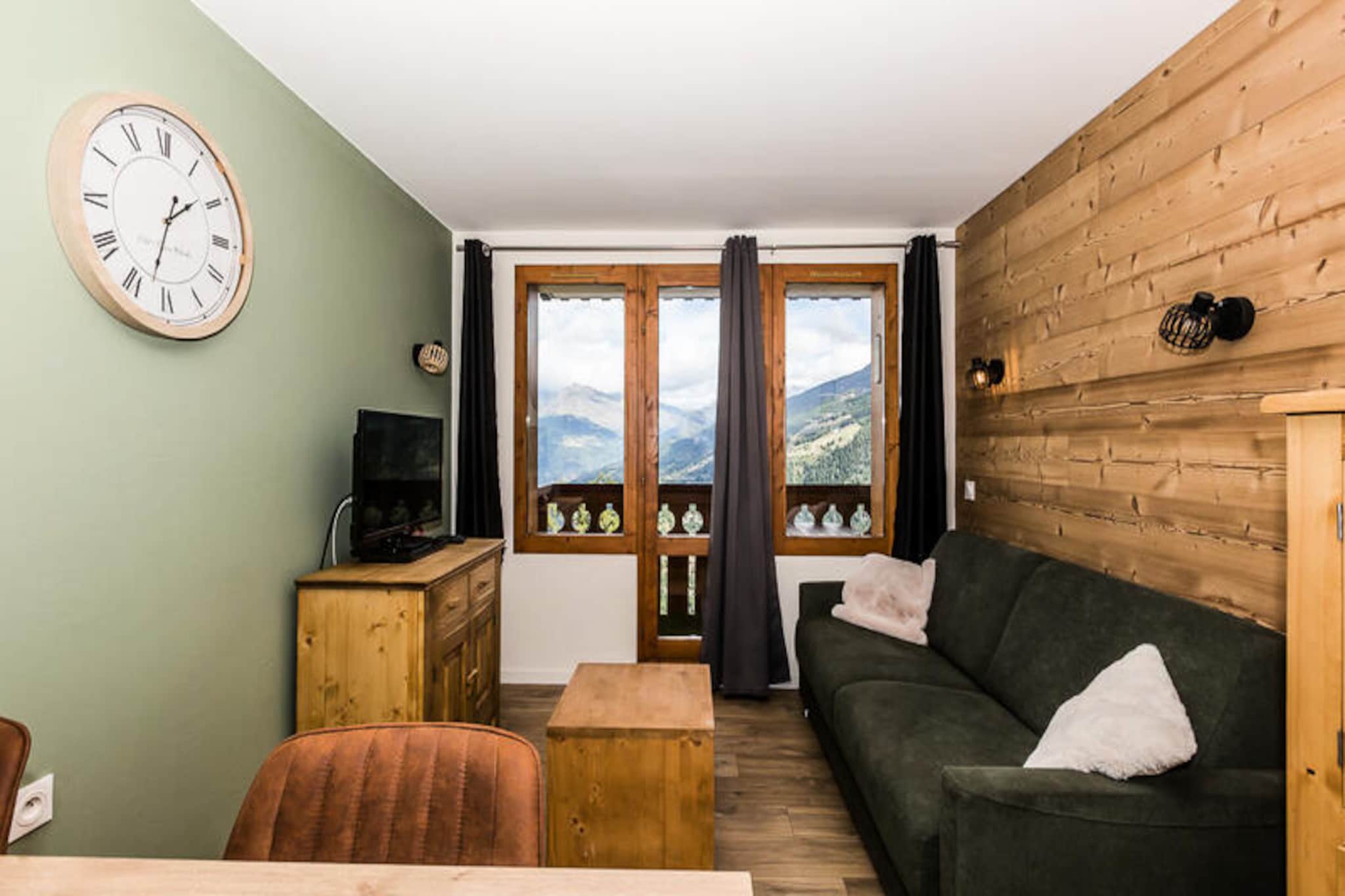 Perched on the slopes of Montchavin Les Coches in the renowned La Plagne ski area, this charming apartment offers a cozy retreat with breathtaking views of Mont Blanc and the valley below. Whether you're here for winter adventures or summer escapes, the residence Le Rami provides direct access to the slopes and is just 900 meters from local shops, ensuring convenience and comfort throughout your stay. Imagine sipping your morning coffee on the northwest-facing balcony, soaking in the alpine serenity before heading out for a day of exploration. \n\nThis fully renovated 2-room apartment is thoughtfully designed to accommodate up to four guests in its 28 m² space. The living room features a comfortable double sofa bed and a flat-screen TV, while the bedroom offers two single beds and another TV for added relaxation. The kitchen is equipped with ceramic hobs, a refrigerator, dishwasher, microwave, kettle, and toaster, making it easy to prepare meals after a day on the slopes. Additional amenities include a boot dryer in the entrance closet, a bathroom with a shower, and a separate WC. End-of-stay cleaning is included, though guests are asked to leave the kitchen tidy and organized. Optional linen and Wi-Fi rentals are available for added convenience. \n\nThe residence also offers free outdoor parking, ski lockers, and pet-friendly accommodations for a small supplement. Beyond the property, the La Plagne area invites you to explore its vast ski domain, scenic hiking trails, and vibrant village life. Whether you're skiing down powdery slopes or enjoying summer festivals, this apartment serves as the perfect base for creating unforgettable alpine memories. With Mont Blanc as your backdrop, every moment here feels like a postcard come to life.