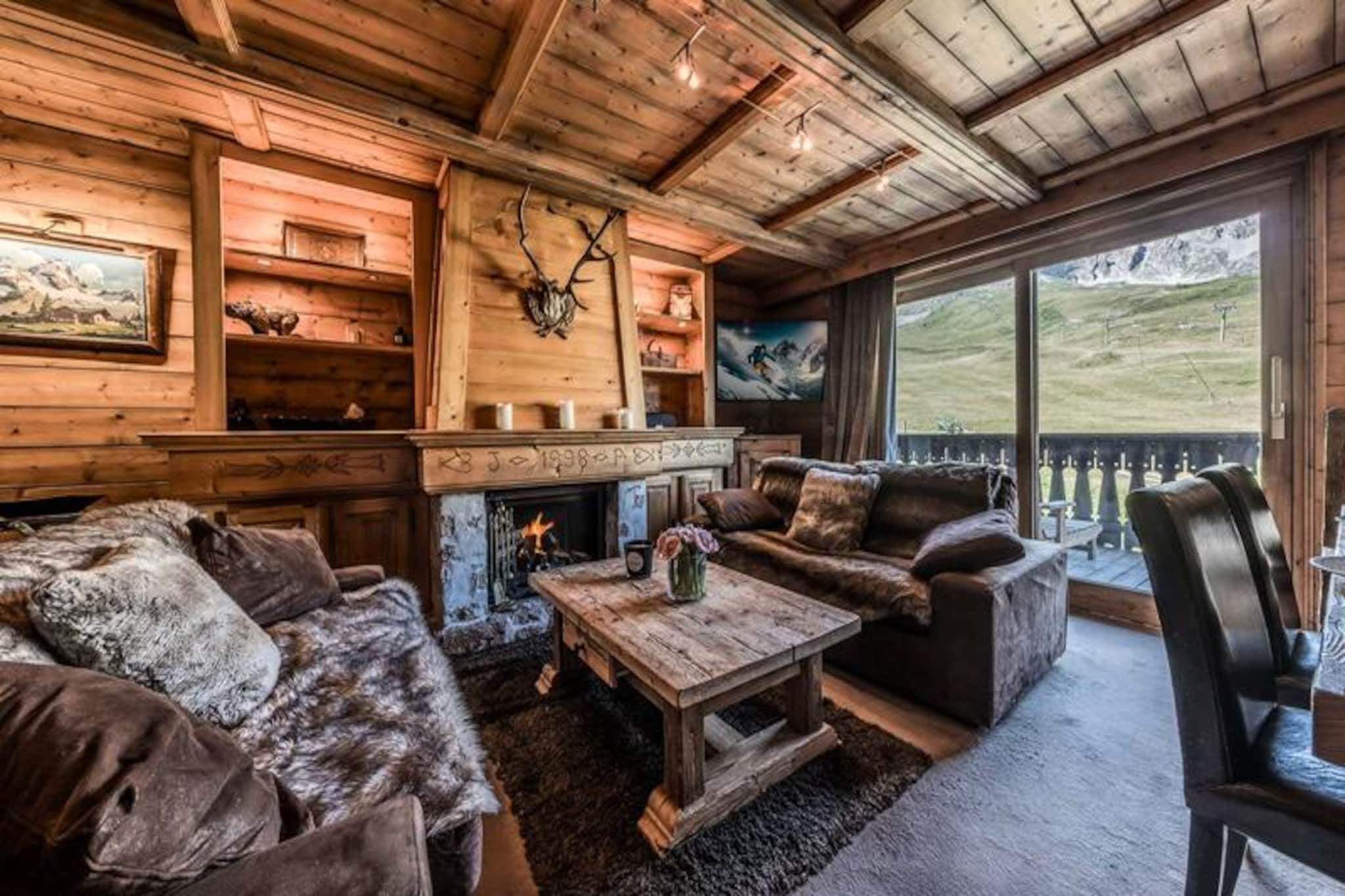 High above the glittering Courchevel 1850, this elegant duplex apartment in the prestigious Nogentil district offers an unparalleled alpine retreat. Imagine waking up to the serene beauty of snow-draped slopes, stepping out onto your private terrace with a steaming cup of coffee, and breathing in the crisp mountain air. With ski-in/ski-out access directly onto the Pralong slope, this property is a haven for winter sports enthusiasts seeking both luxury and convenience.
Spanning 120m², the apartment comfortably accommodates up to six guests across its thoughtfully designed spaces. The ground floor features a cozy living and dining area complete with a fireplace and television, perfect for unwinding after a day on the slopes. The separate, fully equipped kitchen includes modern appliances such as a Nespresso machine and washer-dryer, ensuring all the comforts of home. The double bedroom on this level opens onto a terrace, where two sun loungers and a dining table invite you to soak in the breathtaking views. Upstairs, you’ll find a spacious double bedroom, a charming sleeping alcove with bunk beds, and a luxurious bathroom with a shower, bathtub, and double vanity. Ample storage and high-end amenities complete the experience.
The residence also offers a ski locker with direct slope access, covered parking, and Wi-Fi. Located in the heart of the Three Valleys, the world’s largest ski area, this property is perfectly positioned for exploring Courchevel’s renowned pistes, fine dining, and vibrant après-ski scene. Whether you’re carving through fresh powder or enjoying a quiet evening by the fire, this alpine escape promises unforgettable moments. With linens provided, beds made upon arrival, and optional luxury services available, every detail is designed for your comfort. Make this your home in the mountains and create memories that will last a lifetime.