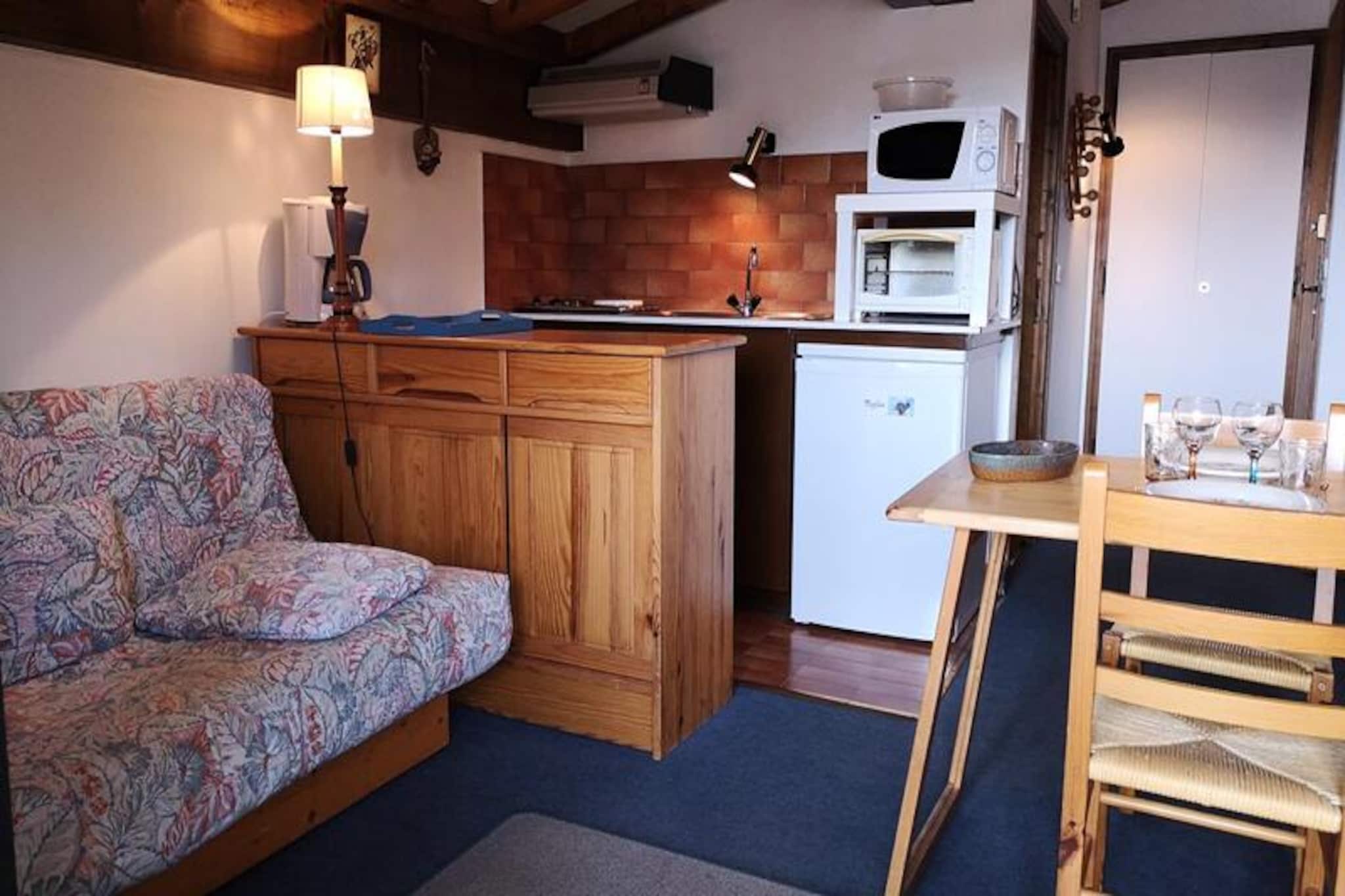 High above the charming alpine village, this cozy studio apartment offers a serene retreat for those seeking the perfect mountain getaway. Bathed in sunlight and nestled within a peaceful residence, the property provides a harmonious blend of comfort and convenience, ideal for couples or small families looking to explore the French Alps. From your private balcony, enjoy sweeping views of the surrounding peaks and breathe in the crisp mountain air, setting the tone for a memorable stay. \n\nThe 19 m² studio is thoughtfully designed to maximize space and comfort. The living room features a sofa bed and two single fold-down beds, seamlessly transitioning from a relaxing lounge area to a restful sleeping space. A compact kitchenette is equipped for preparing meals after a day of adventure, while the bathroom with toilet ensures all essentials are met. The residence also offers practical amenities such as an elevator, a ski locker, and on-site parking, making your stay as hassle-free as possible. Additional services like bed linen, towels, and Wi-Fi are available upon request, ensuring a tailored experience.\n\nSituated in the heart of the village and just steps from the slopes, this location is a haven for winter sports enthusiasts and nature lovers alike. Whether you're skiing down pristine runs, hiking through lush summer trails, or simply soaking in the alpine charm, everything is within easy reach. The village itself boasts a selection of quaint shops, restaurants, and après-ski options, adding to the allure of your alpine escape.\n\nChoose this delightful studio for its unbeatable location, cozy ambiance, and the promise of unforgettable mountain memories. Whether you're here for adventure or relaxation, this property is your gateway to the enchanting French Alps.