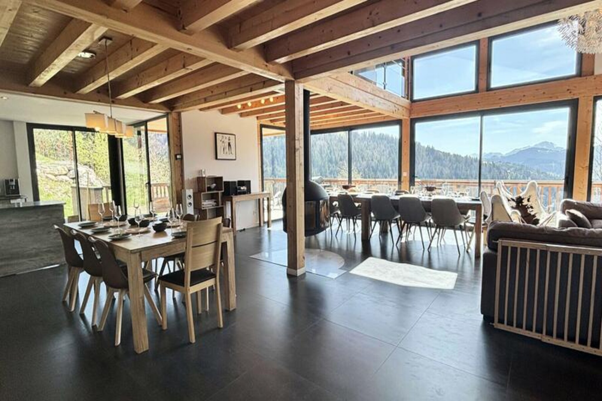 Amidst the serene beauty of the French Alps, Chalet La Bartavelle offers an unforgettable retreat for families and groups seeking a luxurious mountain getaway. With its spacious design and warm ambiance, this detached chalet promises a perfect blend of comfort and alpine charm, surrounded by breathtaking views of forests and peaks. Whether you’re here for winter adventures or summer relaxation, every moment feels like a celebration of nature’s finest offerings. \n\nSpanning 320 m², the chalet accommodates up to 15 guests across six beautifully appointed bedrooms, each offering stunning views of the surrounding landscape. The first floor boasts a bright and airy living/dining area with large bay windows, a suspended wood-burning stove, and a fully equipped open-plan kitchen. A ski room with boot warmers, a laundry room, and a relaxation area featuring a sauna and jacuzzi ensure your stay is as comfortable as it is indulgent. With three shower rooms, a bathroom, and four separate toilets, the chalet is thoughtfully designed for convenience and privacy. \n\nLocated just 800 meters from the charming village center of Notre-Dame-de-Bellecombe, you’ll find easy access to the ESF ski school, local shops, and dining options. In winter, enjoy skiing on pristine slopes, while summer invites you to explore scenic hiking trails and lush alpine meadows. The chalet’s Wi-Fi and three outdoor parking spaces add to the convenience, making it an ideal base for exploring the region. \n\nWhether you’re unwinding in the jacuzzi after a day on the slopes or enjoying a cozy evening by the fire, Chalet La Bartavelle is more than just a place to stay—it’s a destination for creating cherished memories in the heart of the Alps.