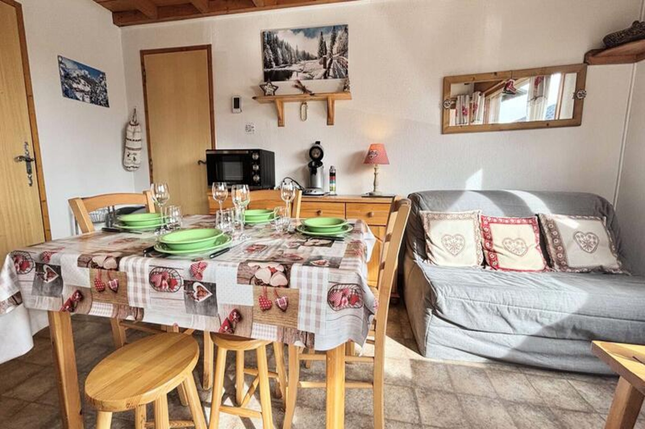 Beneath the towering peaks of the French Alps, this charming ground-floor holiday apartment offers a cozy retreat for adventurers and relaxation seekers alike. Whether you’re here to carve through pristine slopes or simply soak in the alpine tranquility, this property’s unbeatable location at the foot of the pistes ensures every moment is steeped in mountain magic. The nearby toboggan run adds a playful touch to winter days, while the convenience of shops just 50 meters away makes your stay effortless and enjoyable. \n\nInside, the 29m² apartment is thoughtfully designed to maximize comfort and functionality. The living room and kitchen create a welcoming space for shared meals and quiet evenings, while the bedroom with a double bed and the sleeping alcove with two single beds provide restful havens after a day of exploration. A modern shower room and separate WC add to the practicality, and the balcony invites you to breathe in the crisp alpine air as you admire the surrounding scenery. Additional perks include a private parking space reserved for residents and a ski locker for your gear. \n\nThe location is ideal for immersing yourself in the vibrant alpine lifestyle. From thrilling ski runs to leisurely strolls through the village, everything you need is within easy reach. In the warmer months, the area transforms into a paradise for hikers and nature lovers, with trails that wind through breathtaking landscapes. \n\nWhether you’re planning a winter escape or a summer adventure, this apartment promises a memorable stay in the heart of the French Alps. Create lasting memories in a setting that combines comfort, convenience, and the timeless beauty of the mountains.