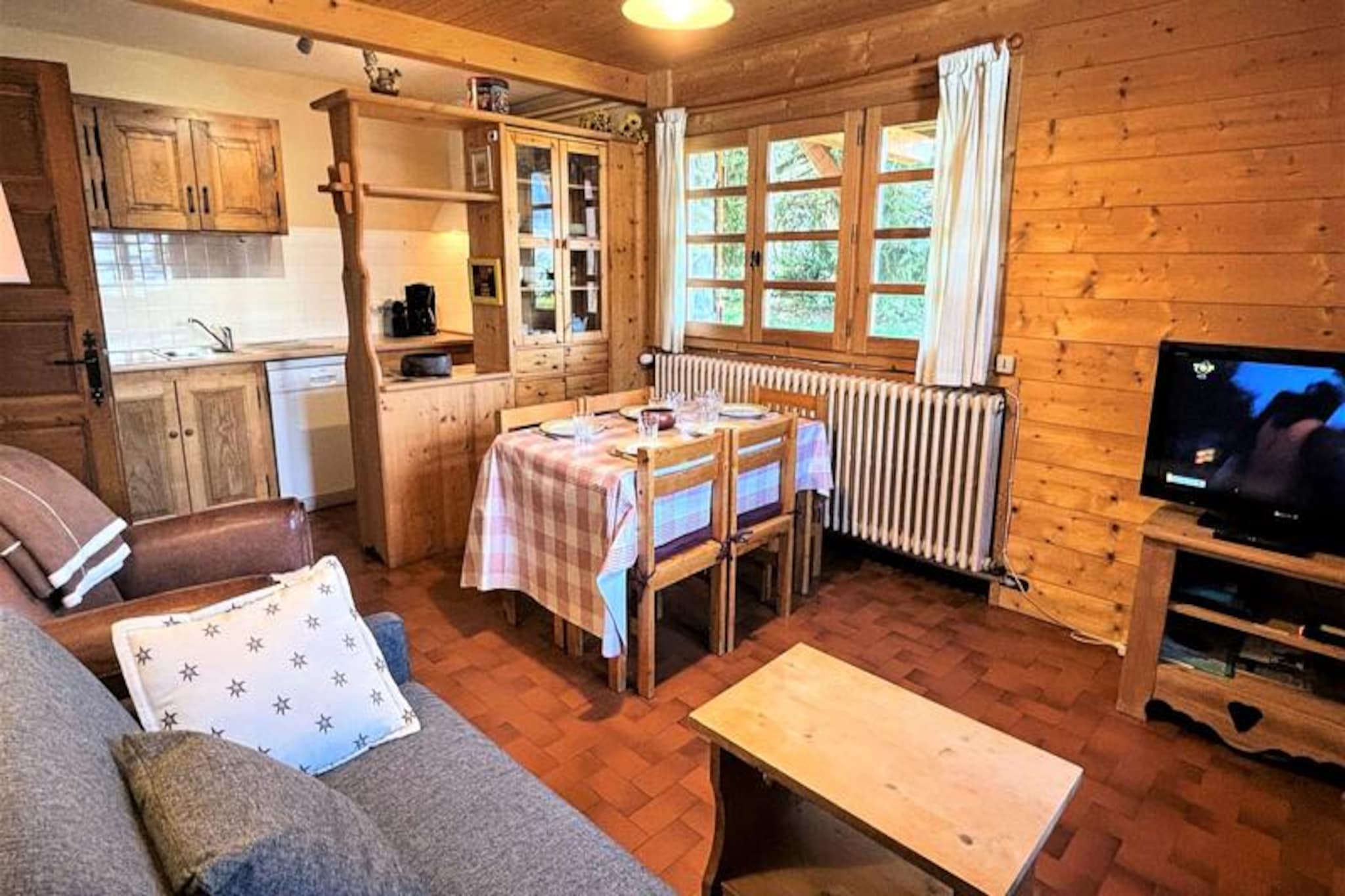 In the heart of the French Alps, where the crisp mountain air invigorates the senses, this charming ground-floor apartment offers a cozy retreat for your alpine adventures. With the ski slopes and resort center just 100 meters away, you’ll find yourself perfectly positioned to embrace the thrill of winter sports or the tranquility of summer hikes. The west-facing garden invites you to unwind and soak in the serene surroundings after a day of exploration. \n\nInside, the apartment is thoughtfully designed to blend comfort and practicality. The open-plan kitchen is fully equipped for preparing hearty meals, while the living room features a double sofa bed for additional sleeping arrangements. The bedroom provides a restful haven with a double bed and a single pull-out bed, ensuring flexibility for families or small groups. Modern amenities like Wi-Fi and Orange TV enhance your stay, while the bathroom with a shower and washing machine adds convenience. A separate WC and a designated ski storage area at the entrance make this rental ideal for active travelers. \n\nBeyond the property, the vibrant resort center offers shops, restaurants, and après-ski options, all within walking distance. Whether you’re gliding down pristine slopes in winter or exploring lush trails in summer, the location ensures easy access to the best of the region. For added convenience, a reserved outdoor parking space is included, and pets are welcome for a small fee. \n\nThis 2-star furnished accommodation promises a delightful alpine escape, where every detail is tailored to create lasting memories. Whether you’re seeking adventure or relaxation, this apartment is your gateway to the enchanting beauty of the French Alps.