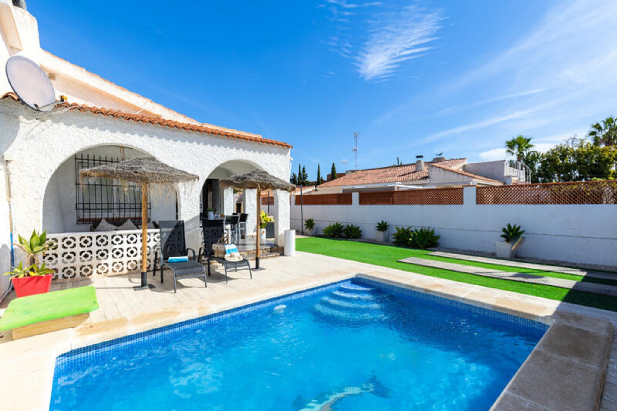In the tranquil residential area of Torrevieja, this charming detached house offers a perfect retreat for families or friends seeking a blend of relaxation and convenience. Surrounded by beautifully landscaped gardens and just a short 10-minute walk from the golden sands of Praia dos Fous, this property invites you to unwind in a serene yet well-connected setting. Whether you’re strolling along the seafront or exploring the vibrant local attractions, every moment here feels like a getaway.
The house comfortably accommodates up to six guests across three cozy bedrooms. The fully equipped kitchen, complete with a microwave, dishwasher, oven, ceramic hob, coffee maker, and kettle, ensures you have everything needed to prepare delicious meals. The living spaces are thoughtfully designed with air conditioning, Wi-Fi, a television, and even a stereo system for your entertainment. Step outside to discover a private swimming pool, open year-round, surrounded by a fenced garden with comfortable furniture and a barbecue area—ideal for sunny afternoons and al fresco dining.
Located near the Habaneras Shopping Centre, cinemas, bowling alleys, and a variety of restaurants, this home places you at the heart of leisure and entertainment. With excellent transport links, you can easily reach the city center, Alicante, Murcia, or even the airport without needing a car. For pet lovers, the property is pet-friendly, ensuring no family member is left behind.
Whether you’re seeking a peaceful escape or an active holiday, this Torrevieja chalet offers the perfect balance of comfort, convenience, and coastal charm. Create unforgettable memories in this idyllic Spanish retreat.