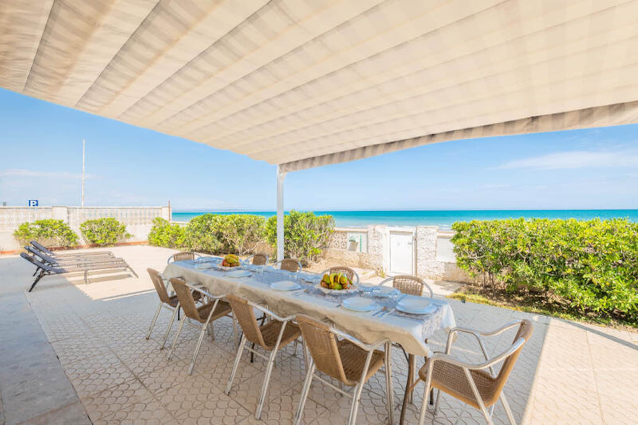 Imagine waking up to the sound of gentle waves and stepping directly from your villa onto the golden sands of Guardamar's pristine beach. This stunning detached villa offers an unparalleled beachfront experience, where the Mediterranean Sea becomes your daily backdrop. With expansive terraces perfect for soaking up the sun or enjoying al fresco meals by the barbecue, this property is a haven for sea lovers seeking tranquility and beauty in equal measure. Guardamar, a charming fishing village, invites you to explore its pine forests, scenic promenade, and authentic Mediterranean lifestyle. 
 
 Inside, the villa boasts four spacious bedrooms, each with its own en-suite bathroom, ensuring privacy and comfort for up to eight guests. The fully renovated kitchen and bathrooms, completed in 2021, provide modern conveniences while maintaining the villa's timeless charm. The kitchen is equipped with everything you need, from a dishwasher to a coffee maker, making it easy to prepare meals for family and friends. The villa also features air conditioning in select rooms, Wi-Fi, a cozy living area with a TV, and outdoor parking, ensuring a seamless and comfortable stay. 
 
 Step outside, and you'll find yourself in a quiet neighborhood of detached villas, offering peace and privacy. For those who love to explore, the beach stretches for 15 kilometers, perfect for sunrise or sunset walks along the shore. Nearby, discover wild dunes and untouched beaches on the way to La Mata, a hidden treasure for nature enthusiasts. Guardamar also boasts exceptional dining options, such as El Bocaito Playa, Restaurant Chema, and La Caïada Playa, where you can indulge in fresh Mediterranean cuisine. 
 
 Whether you're seeking relaxation, adventure, or a taste of authentic Spanish coastal life, this villa offers it all. Create unforgettable memories in this idyllic beachfront retreat, where every moment feels like a dream come true.