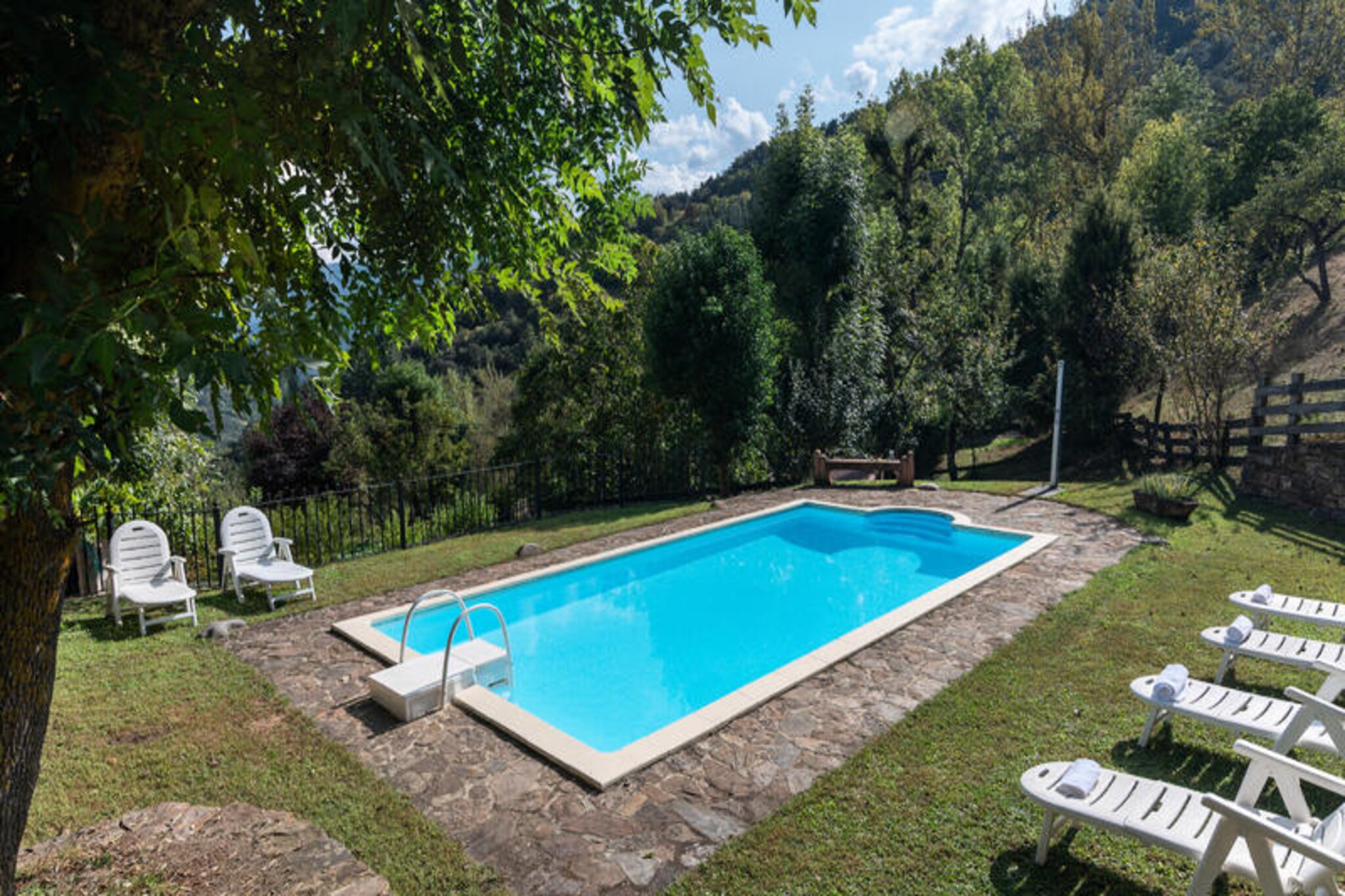 In the heart of Cantabria’s breathtaking Liébana valley, this charming regional house offers an idyllic escape surrounded by the majestic peaks of the Picos de Europa. Here, tranquility reigns supreme, with nature parks enveloping a tiny village of just eight houses. It’s a place where time slows, and the beauty of the mountains becomes your daily backdrop. Whether you’re seeking peaceful solitude or outdoor adventure, this home promises a memorable retreat. 
 
 The house itself is a perfect blend of rustic charm and modern comfort. Its traditional mountain façade welcomes you into a cozy interior featuring two bedrooms, a bathroom, and an additional toilet. The open-plan kitchen and living-dining area, complete with a fireplace, create a warm and inviting space to gather. Step outside to your private garden, where you can relax or enjoy direct access to a shared swimming pool with spectacular mountain views. The layout is thoughtfully designed, with a bedroom and toilet on the ground floor and the main living areas, a second bedroom, and a bathroom on the first floor, ensuring both privacy and convenience. 
 
 Beyond the property, the region offers endless opportunities for exploration. Just 12 km away lies the charming town of Potes, with its cobbled streets and vibrant local culture. For those seeking adventure, the Fuente Dé cable car, 34 km from the house, provides breathtaking views and access to high-altitude trails in the Picos de Europa. After a day of hiking or sightseeing, return to the house to enjoy a barbecue in the communal area or a refreshing swim under the stars. 
 
 This house is more than just a place to stay—it’s an invitation to experience the serene beauty and timeless traditions of rural Cantabria. Perfect for couples, families, or small groups, it’s a haven for those who value nature, relaxation, and authentic experiences.