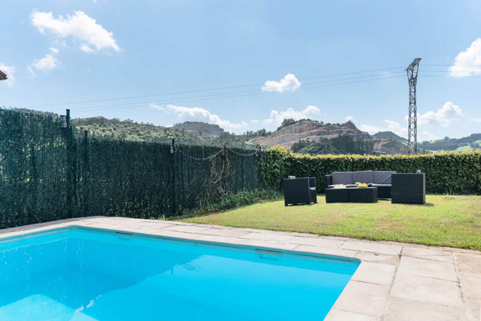 Set amidst the serene landscapes of Cantabria, this spacious and inviting house is a haven for those seeking tranquility and adventure. With stunning mountain views and a private pool, it offers the perfect escape just 10 minutes from the vibrant city of Santander. The nearby Liencres Dunes Natural Park, only a 7-minute drive away, boasts pristine beaches and breathtaking scenery, making it an ideal destination for nature lovers and surf enthusiasts alike. Whether you're looking to unwind by the pool or explore the surrounding beauty, this location promises an unforgettable experience. \n\nThe house is thoughtfully designed to provide both comfort and functionality. On the ground floor, you'll find a cozy bedroom, a modern bathroom, a spacious living room that opens onto the terrace and pool, and a fully equipped kitchen with high-quality appliances. The first floor features three double bedrooms, including one with an en-suite bathroom, and an additional shared bathroom. The second floor offers an open-plan space with a double bed, perfect for extra guests or a quiet retreat. A private garage, accessible from both the exterior and ground floor, adds convenience to your stay.\n\nThe outdoor area is a true highlight, with a fully fenced property ensuring privacy and a private pool surrounded by comfortable outdoor furniture. The terrace is perfect for al fresco dining or simply soaking up the Spanish sun. Surf enthusiasts will appreciate the proximity to Liencres, a renowned surfing destination with exceptional conditions and a stunning natural backdrop of dunes and cliffs. Surfboards can be easily stored in the garage or in a designated outdoor area.\n\nWhether you're here to explore the rich culture of Cantabria, enjoy the outdoors, or simply relax in a peaceful setting, this house offers the perfect base for your holiday. With its unbeatable location and thoughtful amenities, it's a place where cherished memories are made.