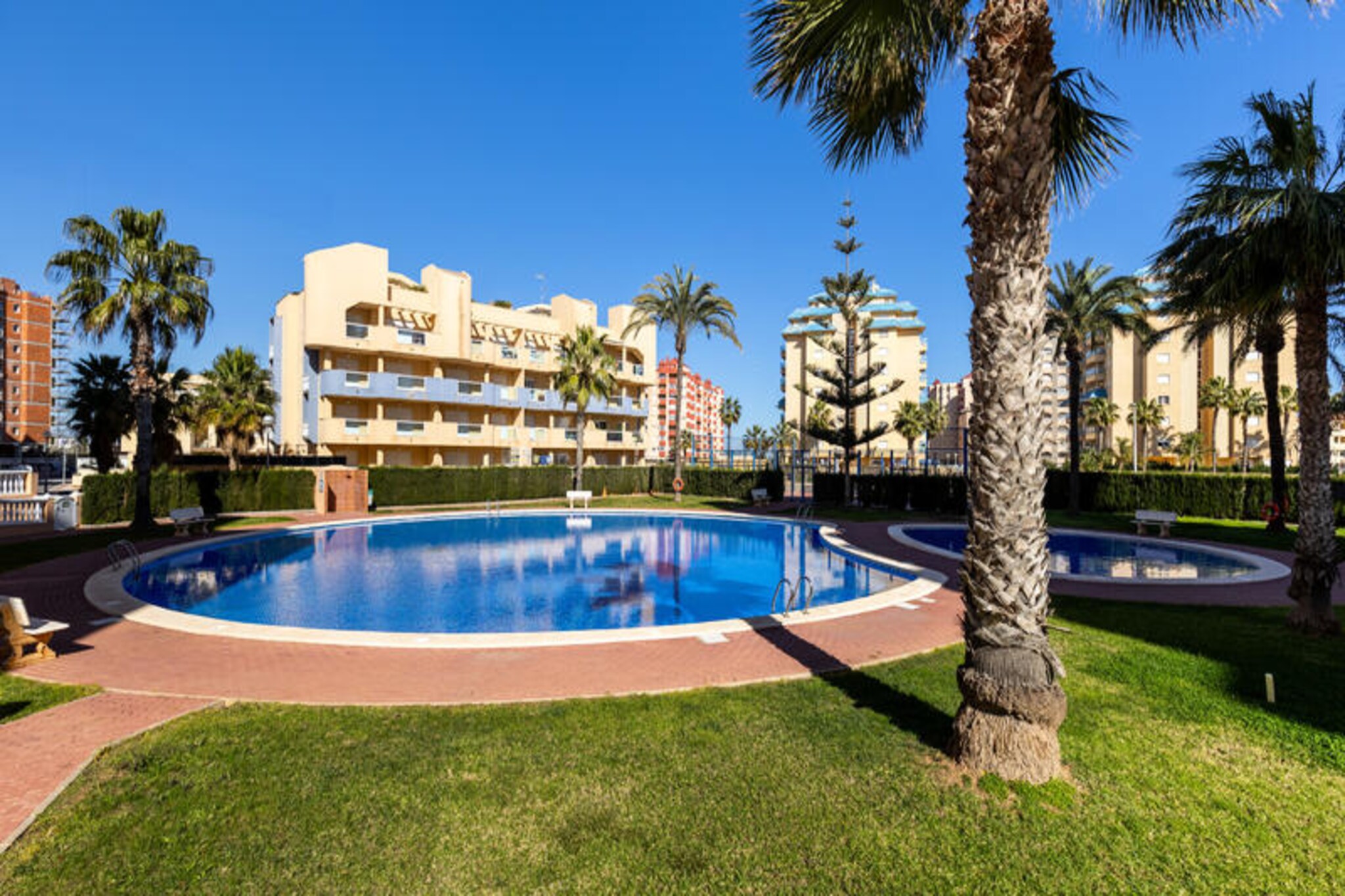 Where the Mediterranean meets the Mar Menor, this stunning semi-detached house in La Manga del Mar Menor offers a unique coastal retreat. Wake up to the soothing sound of waves and enjoy the privilege of being surrounded by two seas, each with its own charm. Whether you're seeking relaxation or adventure, this home provides the perfect setting for an unforgettable holiday.
Inside, the house boasts three spacious bedrooms and two modern bathrooms, comfortably accommodating up to ten guests. The interiors are thoughtfully designed for your comfort, featuring air conditioning and heating to ensure a pleasant stay year-round. The fully equipped kitchen and inviting living spaces make it easy to gather with loved ones, while the detached garage provides convenience and security for your vehicle. Step outside to enjoy the expansive terraces, ideal for soaking up the sun or savoring a quiet evening with sea views.
The property is part of a community that includes a refreshing swimming pool, perfect for cooling off on warm days. For water sports enthusiasts, the nearby marina offers endless opportunities for sailing, kayaking, and more. Nature lovers will be thrilled by the proximity to Calblanque Natural Park, a haven of unspoiled beauty, and the iconic Cap de Palos, renowned for its scuba diving spots. Explore the Battery of Ashes hiking trail, steeped in history, or marvel at the dramatic canyons and breathtaking views of the Spanish Civil War sites. After a day of adventure, treat yourself to a delicious paella at the beachside restaurant.
This home is more than just a place to stay—it's an invitation to immerse yourself in the natural beauty, history, and vibrant culture of La Manga del Mar Menor. Whether you're here for a family getaway or a group retreat, this exceptional property promises memories to last a lifetime.