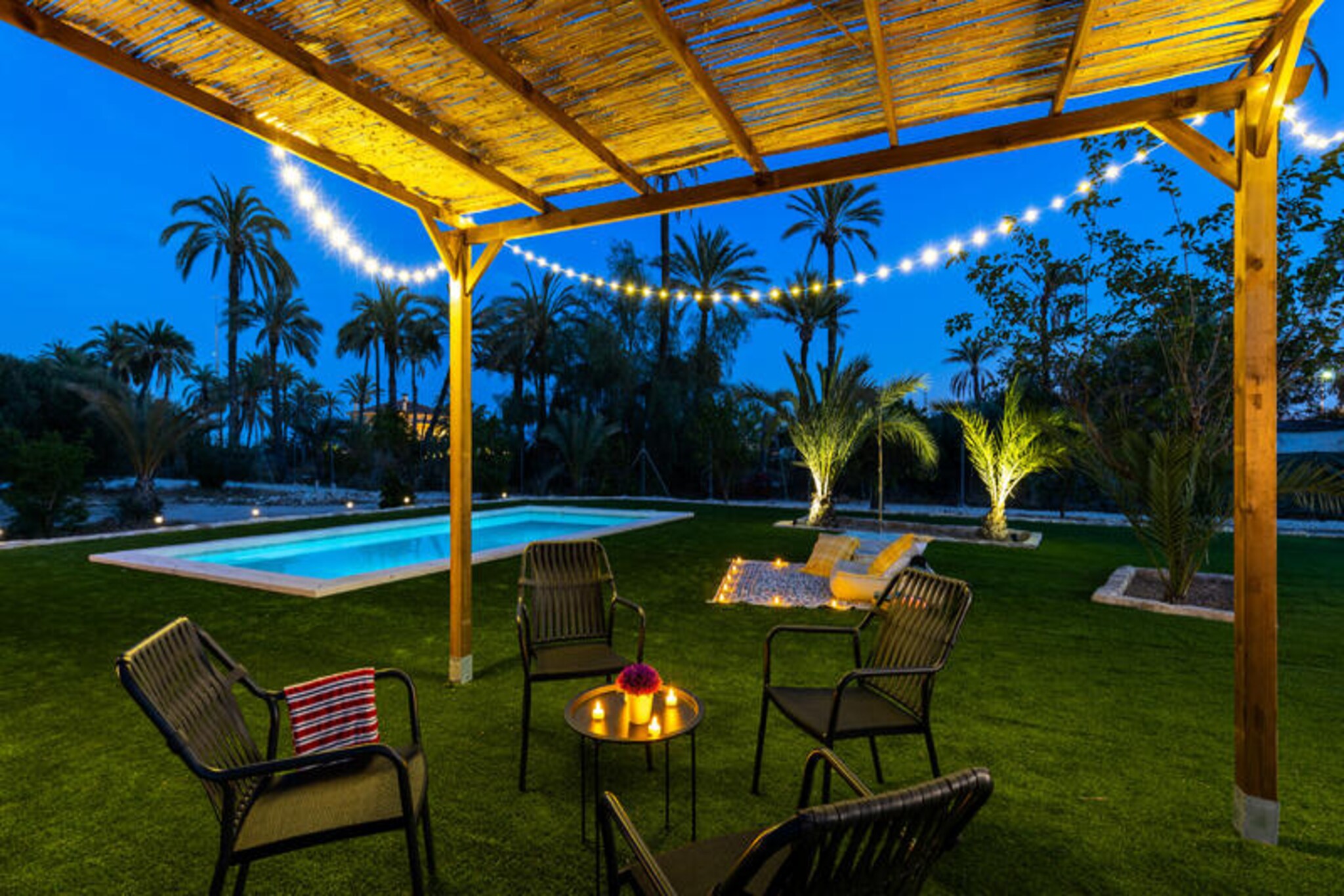 Step into a timeless retreat where history and luxury intertwine. This stunning property, dating back to the last century, is nestled just 2 km from Elche and surrounded by the enchanting beauty of century-old palm trees. A serene oasis awaits you, complete with a private pool and a barbecue area, offering the perfect setting for unforgettable moments with family or friends. The natural charm of this exclusive estate creates an atmosphere of elegance and tranquility, ideal for a rejuvenating getaway.
Inside, the spacious and sunlit living and dining areas invite relaxation and joyful gatherings. The fully equipped kitchen, featuring state-of-the-art appliances, is a haven for culinary enthusiasts, while each of the four bedrooms boasts its own ensuite bathroom, ensuring privacy and comfort for all guests. An additional bathroom adds extra convenience. Upstairs, two of the bedrooms provide a personal sanctuary, while the main floor hosts the remaining two, seamlessly blending style and functionality. Independent air conditioning in every room guarantees a comfortable stay, no matter the season.
Outside, the property truly shines. The inviting pool and barbecue area set the stage for al fresco dining and celebrations, while a dedicated playground ensures endless fun for children. With parking for up to eight cars, convenience is at your fingertips. Beyond the property, the wonders of Elche await. Explore the magnificent Elche Palm Grove, a UNESCO World Heritage Site, just 4 km away, or visit the Alcudia Museum, only 1 km from your doorstep. For beach lovers, the pristine Marina beaches are a mere 16 km away, while nature enthusiasts will delight in the nearby El Hondo Natural Park, just 13 km away. Supermarkets and restaurants are conveniently located 5 km away, making it easy to enjoy local flavors and essentials.
Whether you’re seeking relaxation, adventure, or a mix of both, this exceptional property offers a harmonious blend of nature, comfort, and privacy. Escape to your own slice of paradise in Elche and create memories that will last a lifetime.