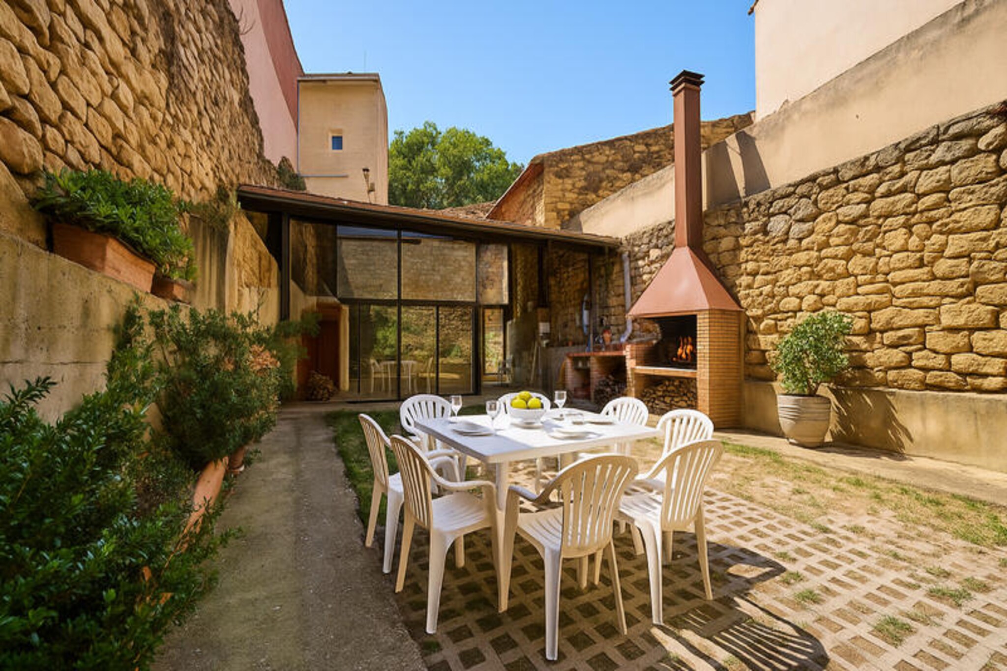 Amid the rolling hills and sunlit vineyards of Rioja Alavesa, this enchanting 18th-century property offers a timeless retreat for wine enthusiasts and nature lovers alike. Located in the picturesque village of Villabuena de Álava, where winemaking traditions run deep, this home invites you to immerse yourself in the region’s rich heritage and breathtaking landscapes. From its charming stone façade to its panoramic terrace views, every corner exudes warmth and authenticity.
The house is thoughtfully designed across three floors, blending historic charm with modern comfort. On the ground floor, a cozy living and dining area leads to a fully equipped kitchen with direct access to a traditional wine cellar—a perfect space to savor local vintages. A few steps down, you’ll find a full bathroom. The first floor boasts two spacious double bedrooms and a luxurious bathroom with both a bathtub and shower. On the second floor, a second living room provides a quiet retreat, alongside another double bedroom, a bathroom with a shower, and a terrace offering sweeping views of the village and surrounding vineyards. Across the street, a private parking area includes a barbecue zone and an additional toilet, ideal for outdoor gatherings.
Wine lovers will be delighted by the property’s proximity to some of the region’s most renowned wineries. Bodegas Izadi and Viña Izadi are just 300 meters away, while Bodegas Luis Cañas is a short 500-meter stroll. For those eager to explore further, Bodegas Baigorri and Casa Primicia are within easy reach, promising unforgettable tasting experiences. Beyond wine, the area is perfect for scenic walks, cycling, and soaking in the tranquil beauty of Rioja Alavesa.
Whether you’re here to indulge in world-class wine, explore the charm of a historic village, or simply unwind in a serene setting, this property offers the perfect base for an unforgettable getaway. Let the magic of Rioja Alavesa captivate you as you create memories to last a lifetime.