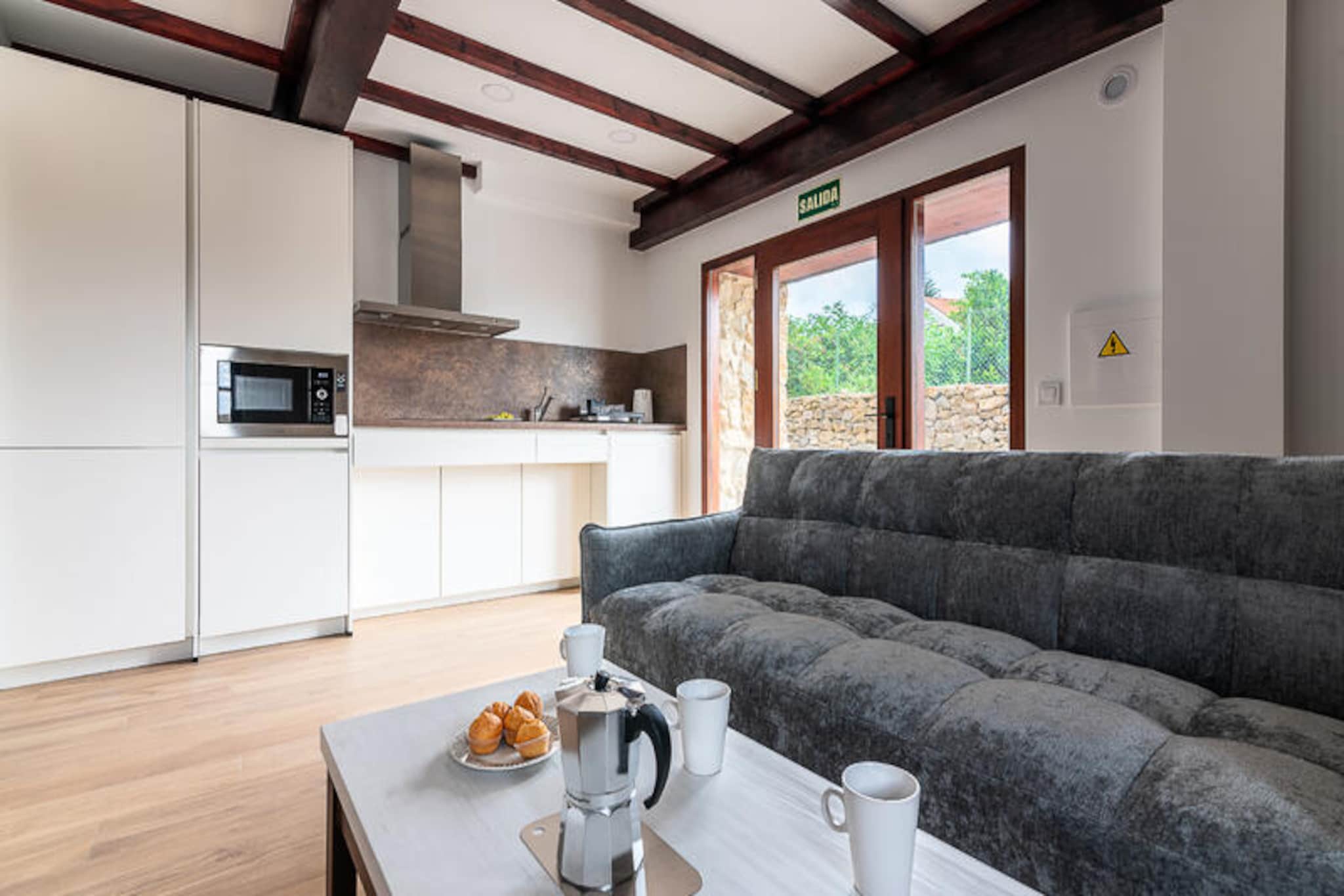 In the heart of a picturesque coastal village, this stunning newly built apartment offers a perfect blend of modern comfort and historic charm. Set within a protected building with a beautifully preserved 19th-century facade, this residence seamlessly combines heritage with contemporary design. Scheduled for completion in 2025, the apartment is fully adapted for accessibility, ensuring a welcoming stay for all guests. Just a five-minute stroll from the pristine beaches of Marzán and Los Caballos, it’s the ideal retreat for those seeking relaxation by the sea or an active exploration of Cantabria’s treasures. 
 
 Inside, the apartment is thoughtfully designed for both comfort and functionality. The open-plan living and dining area connects to a modern kitchen, creating a bright and inviting space to unwind. The double bedroom offers a serene retreat, while the bathroom, equipped with grab bars and a walk-in shower, ensures ease of use for guests with mobility needs. Every detail has been carefully considered to provide a seamless and enjoyable stay, from wide doorways to the absence of architectural barriers. 
 
 The communal outdoor gardens are perfect for soaking in the breathtaking views of the sea and surrounding mountains. Whether you’re enjoying a quiet moment in nature or planning your next adventure, the location offers endless possibilities. Just 15 minutes from Santander, 18 minutes from the medieval charm of Santillana del Mar, and 25 minutes from the wildlife haven of Cabárceno Park, this apartment is a gateway to Cantabria’s most iconic destinations. 
 
 For surfing enthusiasts, Berria Beach is a short drive away, while golf lovers will appreciate the proximity to Golf Celia Barquín Abra del Pas, just nine minutes from the property. With additional courses within a 30-minute radius, it’s a golfer’s paradise. Whether you’re here to relax, explore, or indulge in your favorite activities, this apartment promises an unforgettable coastal getaway.